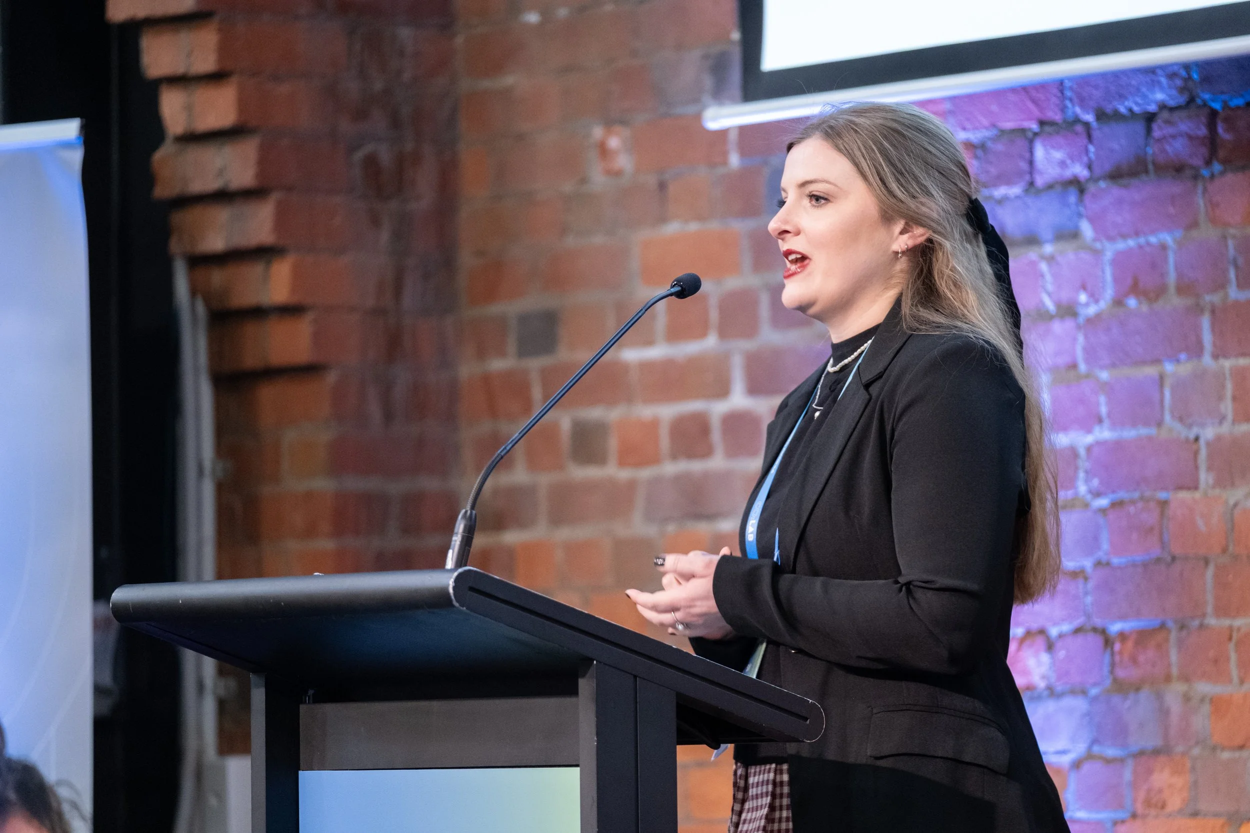 A speaker at the podium at the Co:Lab event