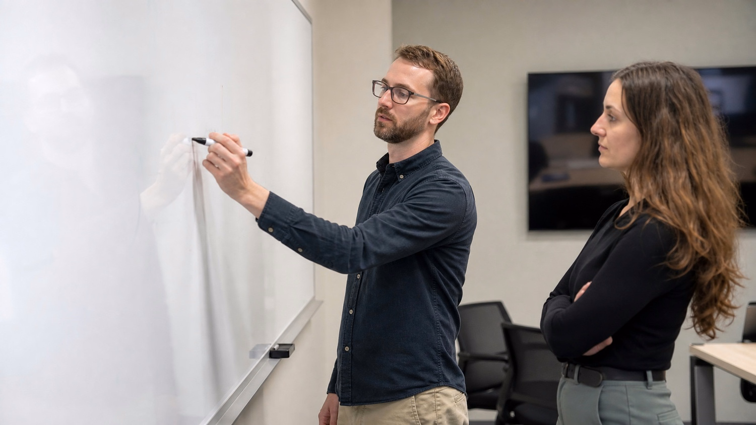 WHITEBOARD SESSION An IT professional one or two people standing at a whiteb
