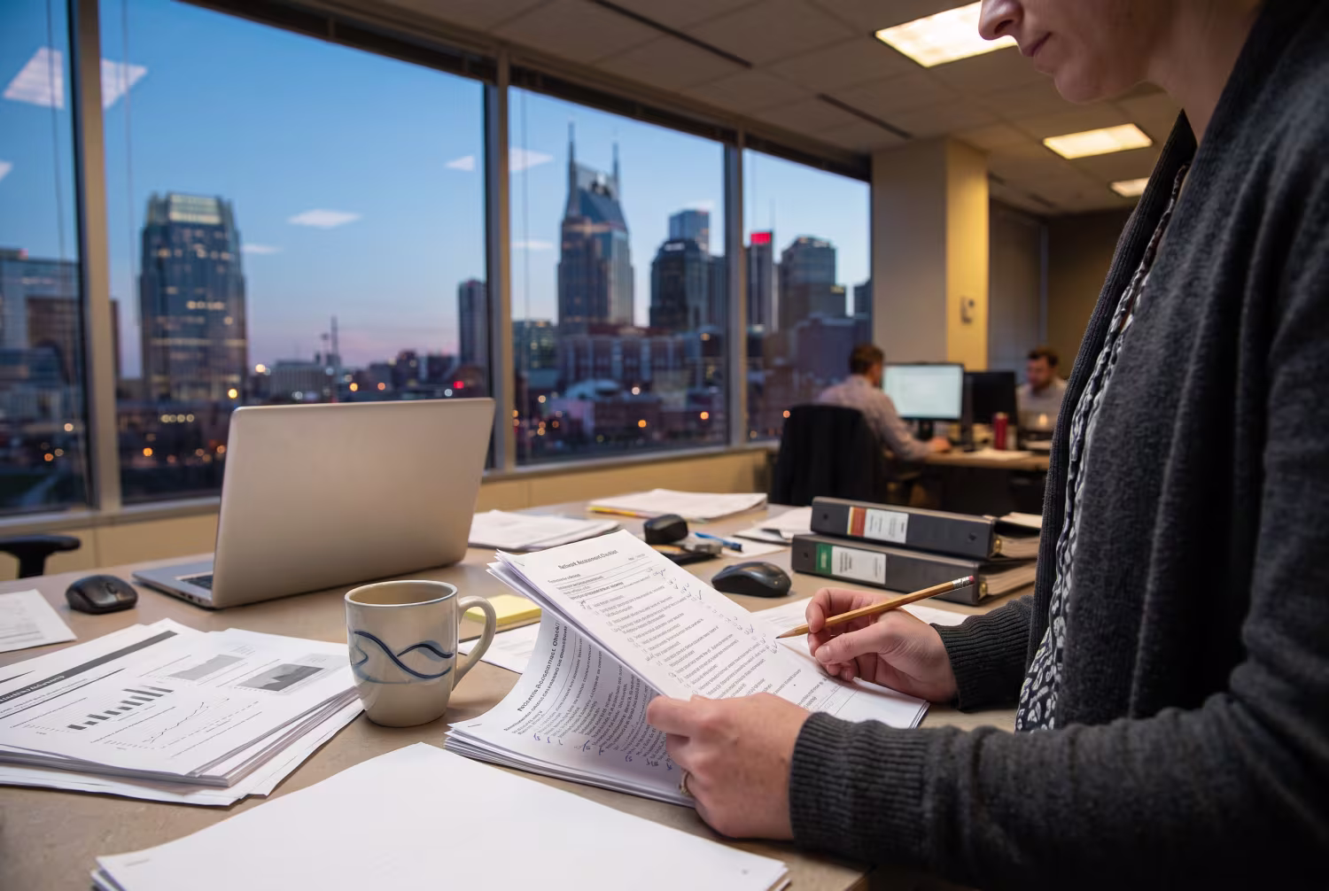 Consulting analyst reviewing a network assessment checklist in Nashville office