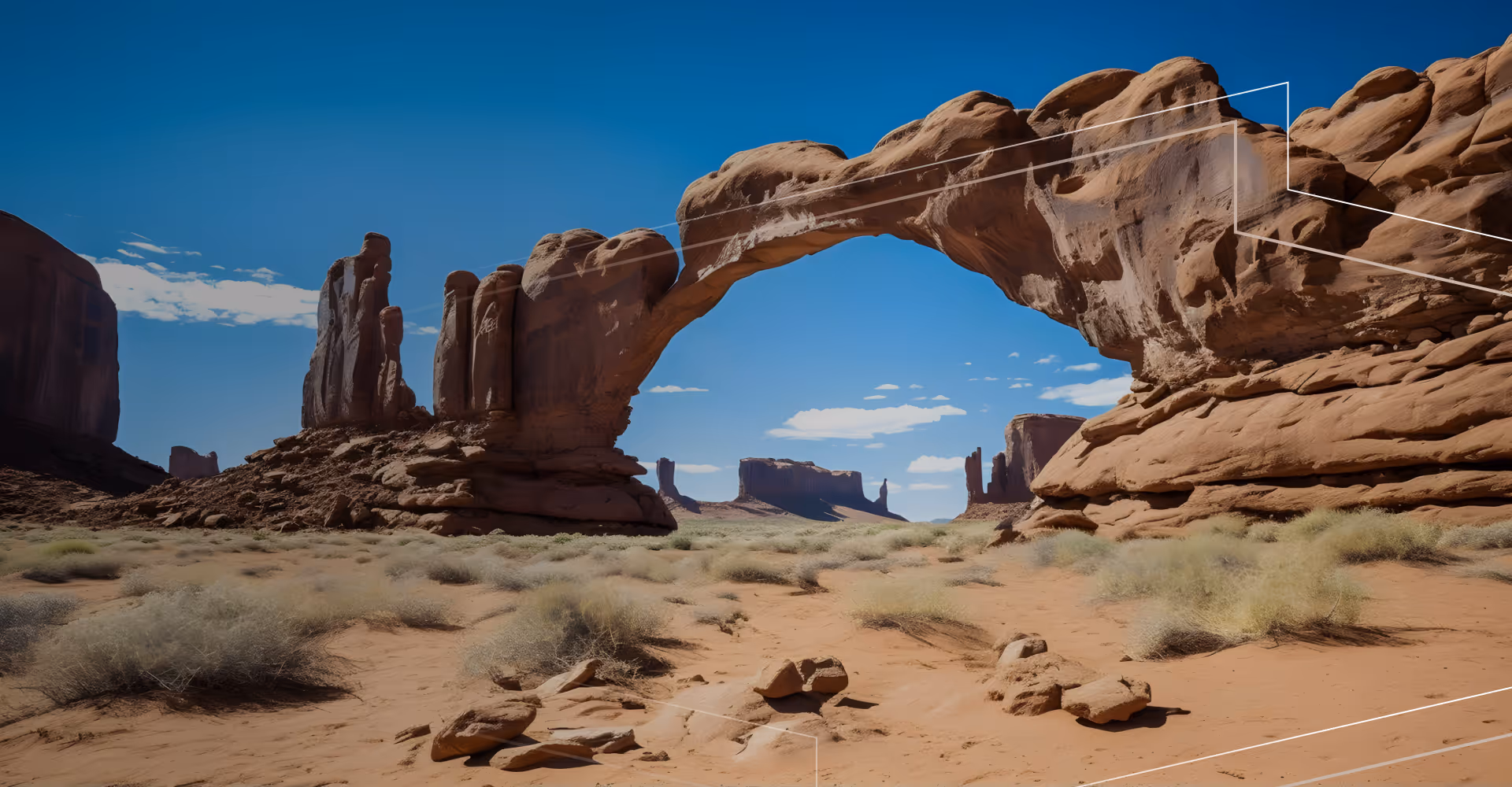 Natural sandstone arch in a desert landscape under a clear blue sky.