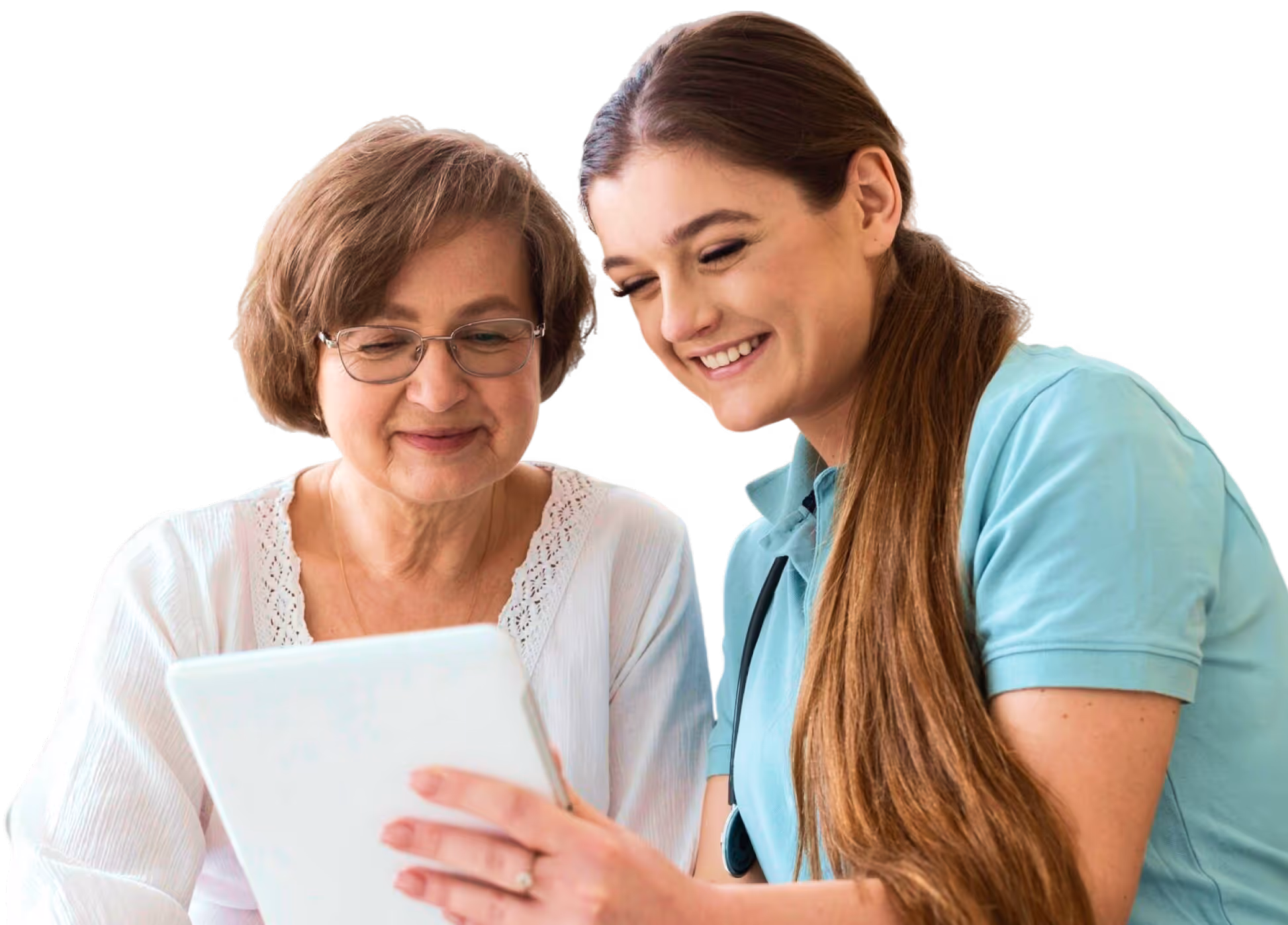 Smiling young female nurse shows a tablet to an older woman wearing glasses and a white blouse.