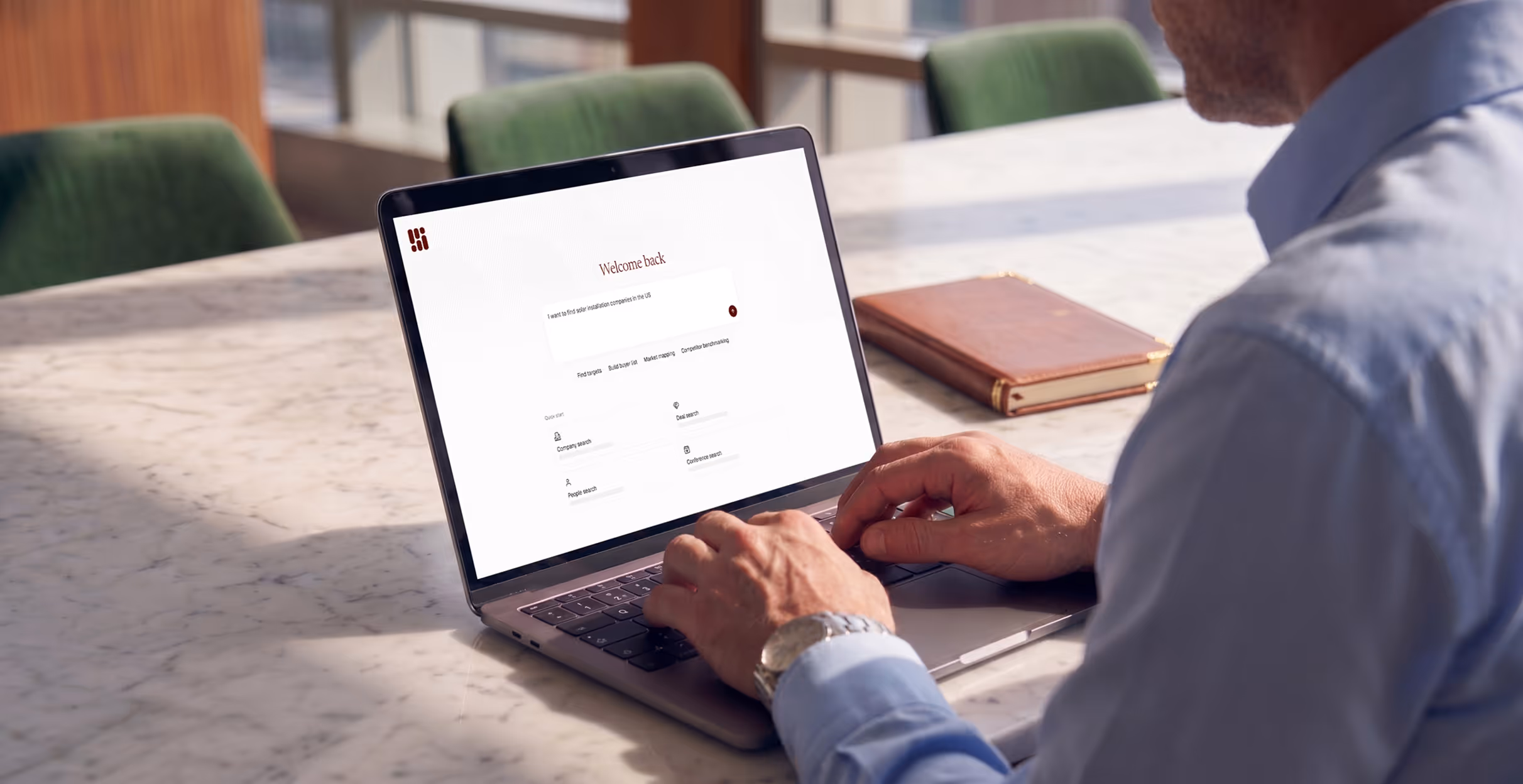Man typing on laptop showing Inven welcome screen with search options and workspace menu.