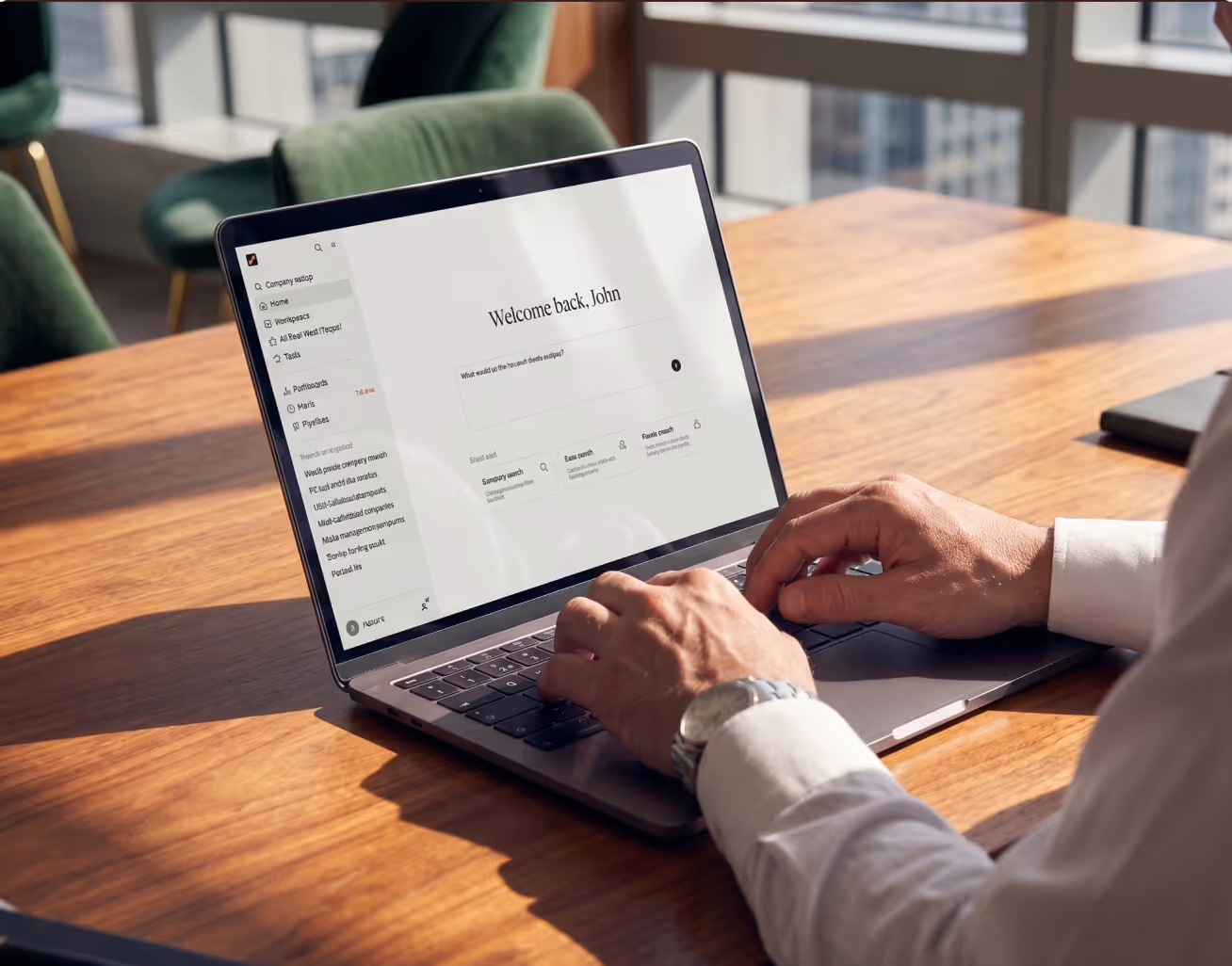 Person typing on a laptop showing a business dashboard with a welcome message on screen.