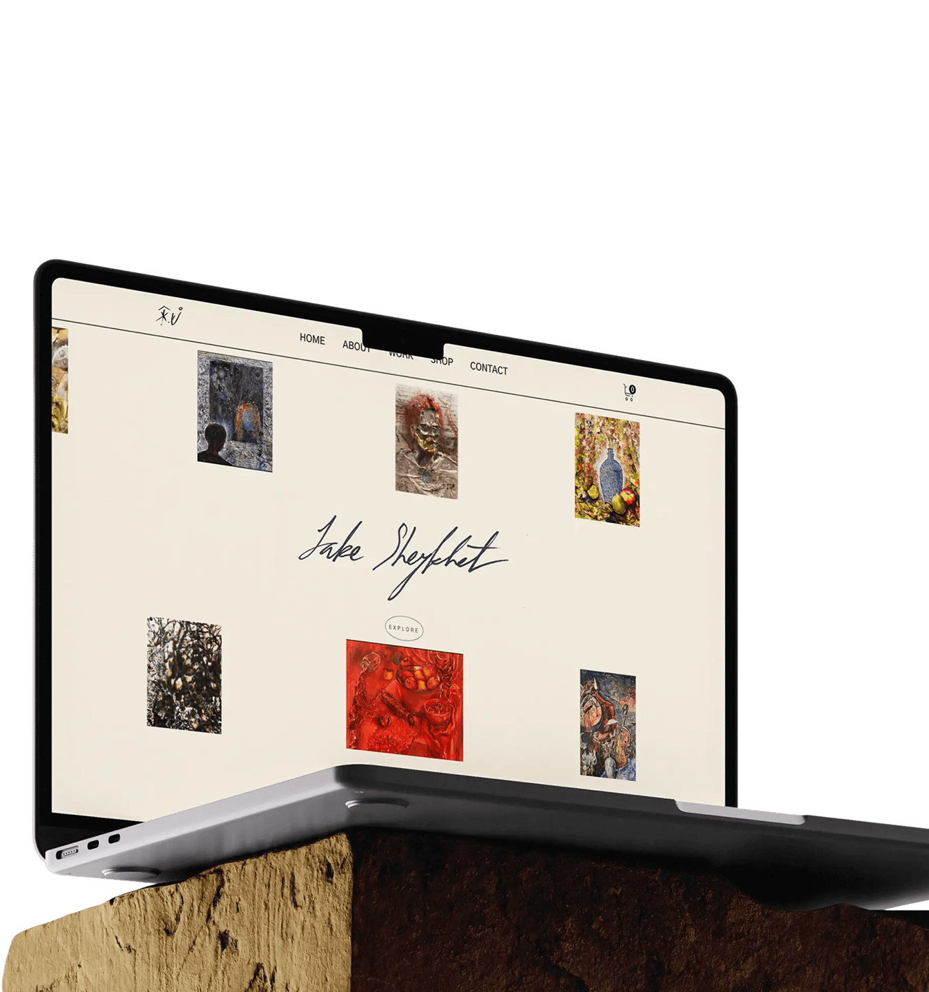 Open laptop on stone with art website showing images and the signature Jake Shepherd.