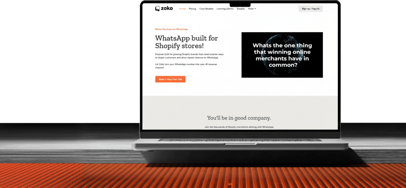 Open laptop on table displaying Zoko website about WhatsApp built for Shopify stores and free trial.