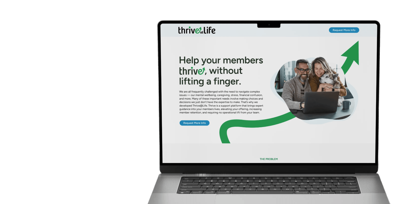 Laptop screen showing Thrive at Life webpage with a couple and dog, plus text about member support.