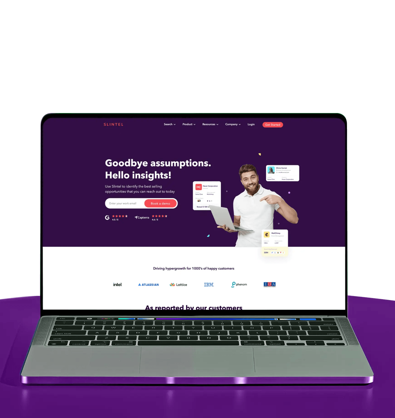 Laptop displaying Slintel website homepage with a man holding a laptop and text about insights and booking a demo.