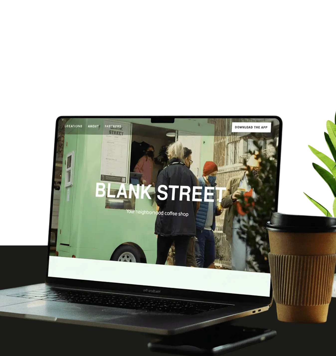 Laptop screen showing Blank Street coffee shop website with people ordering at a green cart outdoors.