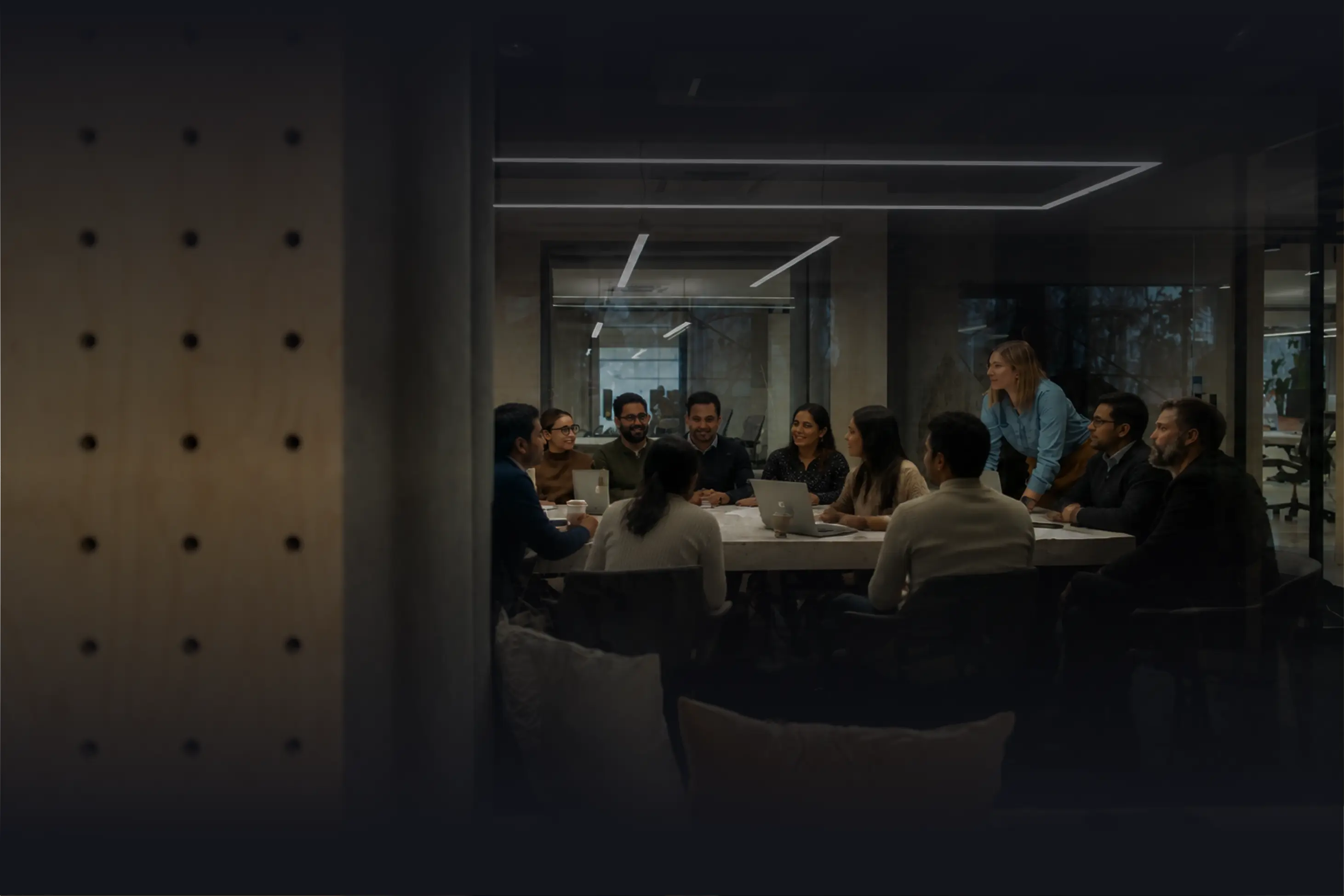 Group of diverse professionals having a meeting around a conference table in a modern office.