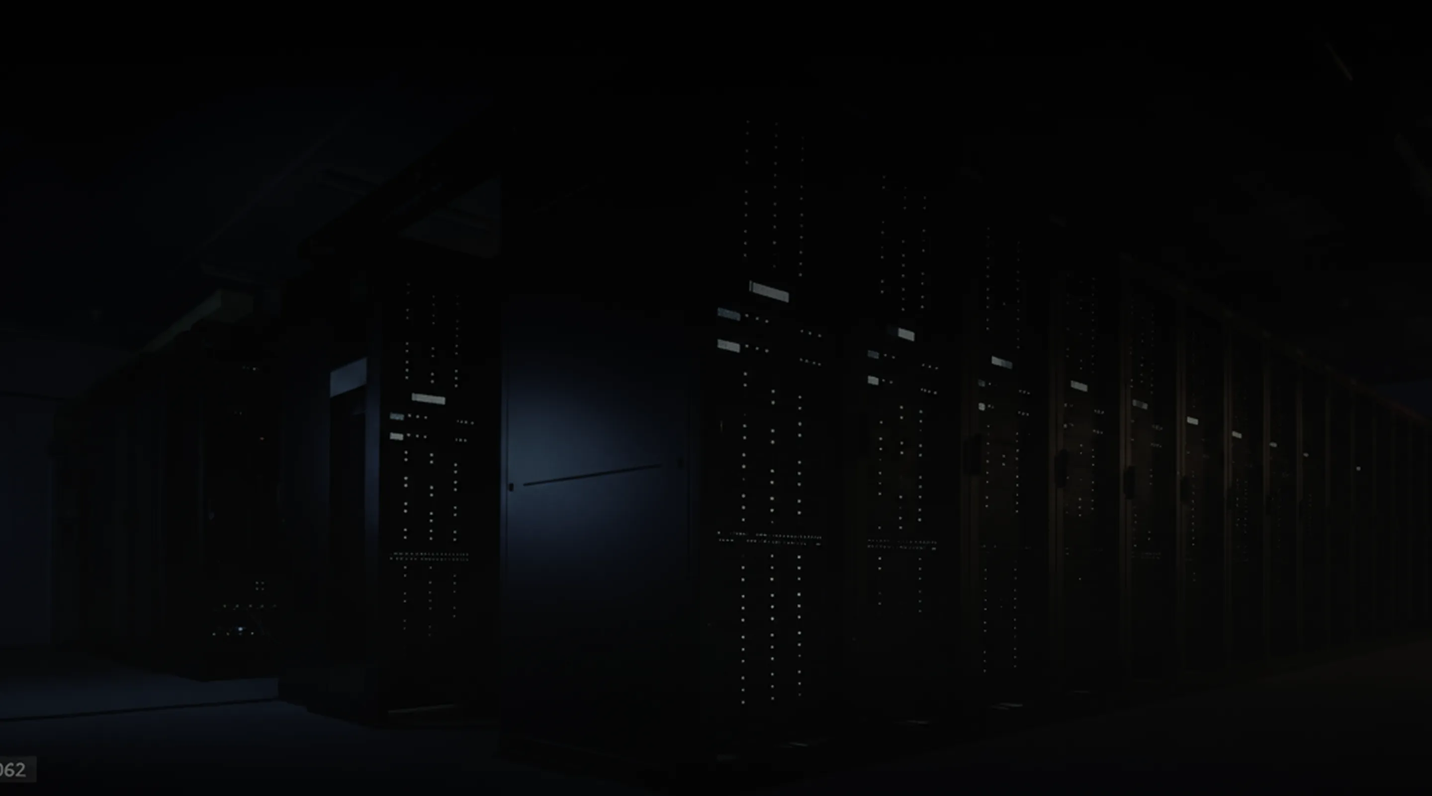 Rows of dark server racks with illuminated panels in a dimly lit data center.