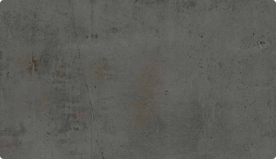 Raue Betonoberfläche mit kleinen Rissen und unregelmäßigen Flecken in Grau.