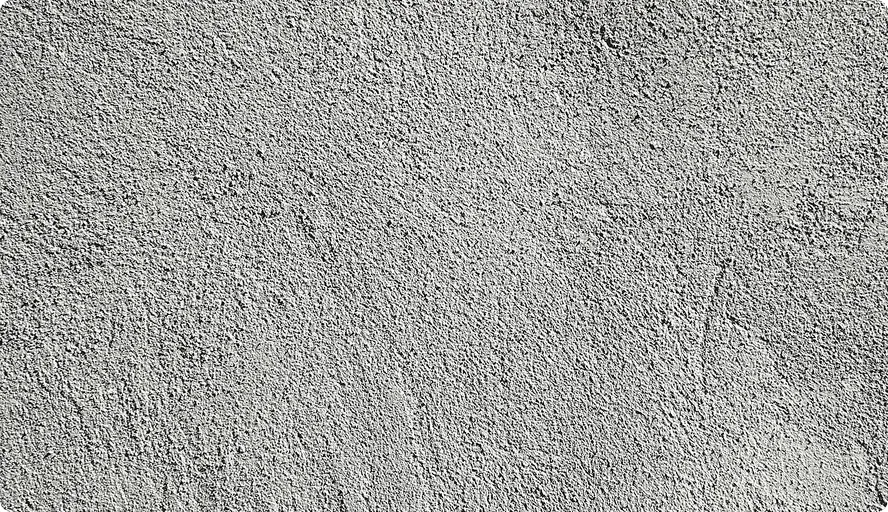 Grobe graue Betonwand mit einer strukturierten, unregelmäßigen Oberfläche.