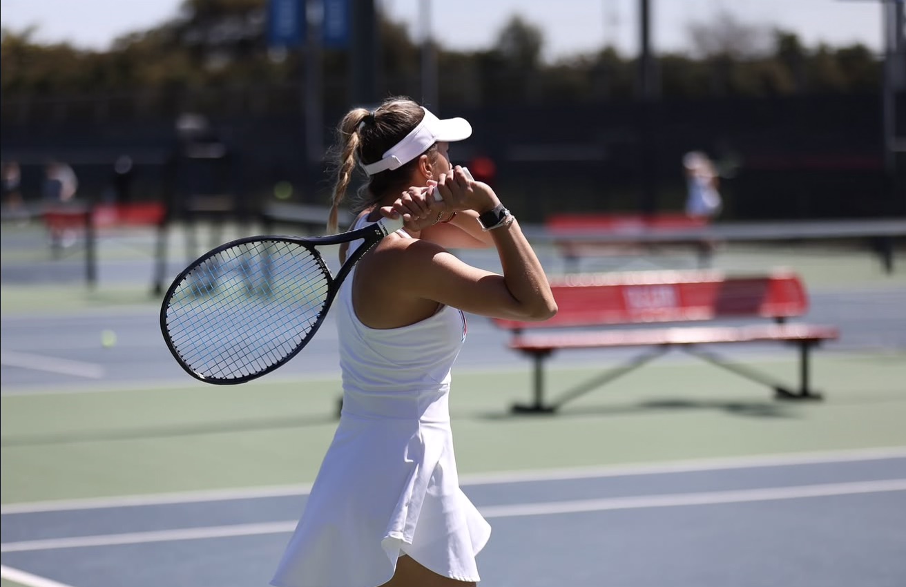 Tennis coach evaluating player on court
