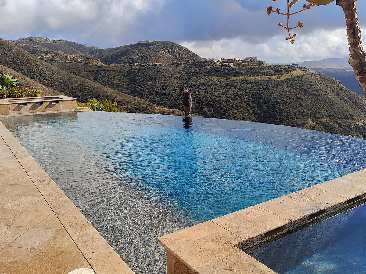 Beachside Pool Service performing pool maintenance for a Cielo property.
