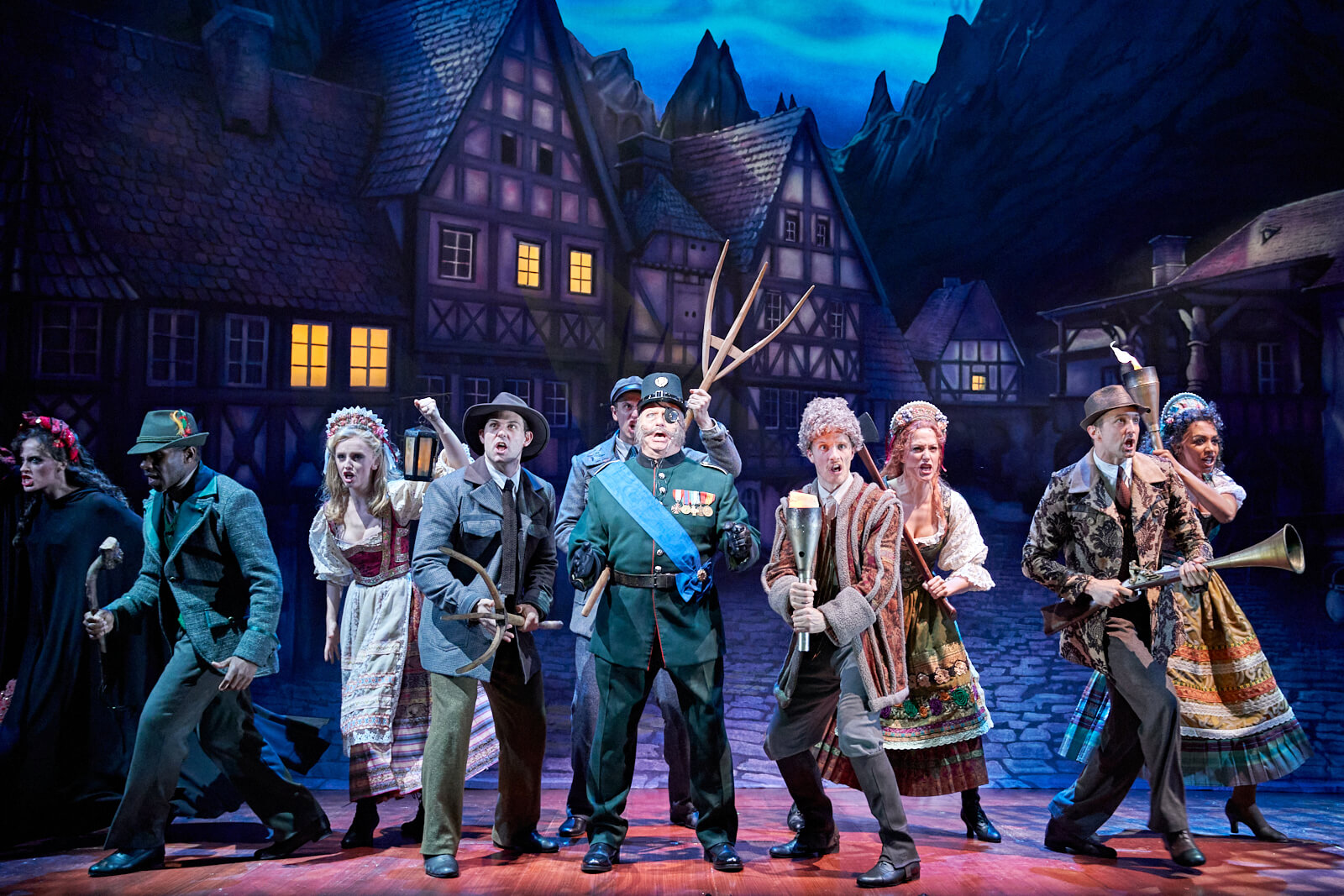 Inspector Kemp (Patrick Clancy) sings "Hang Him Til He's Dead" with the angry villagers of Transylvania backing him up with various weapons. 