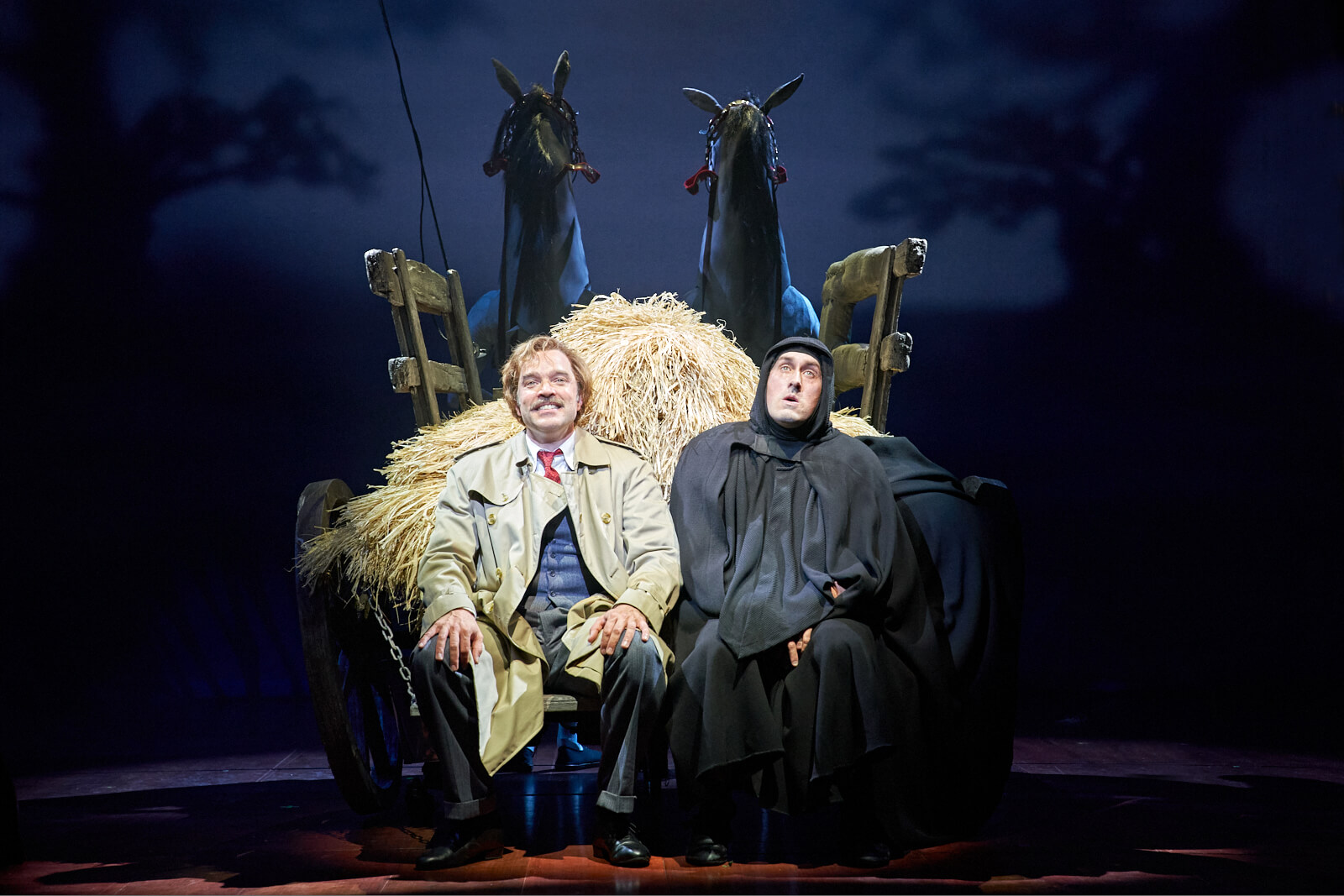 Sitting in a horse drawn carriage full of hay, Dr. Frankenstein (Hadley Fraser) and Igor (Ross Noble) smile as they finish singing the number "Together Again".