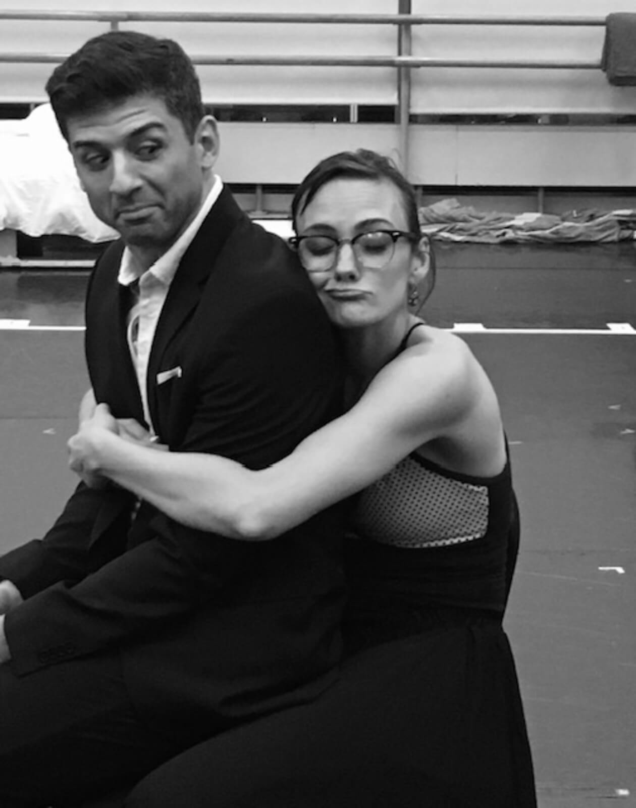 Rehearsal photo of dance captain Leah Hofmann hugging Tony Yazbeck.