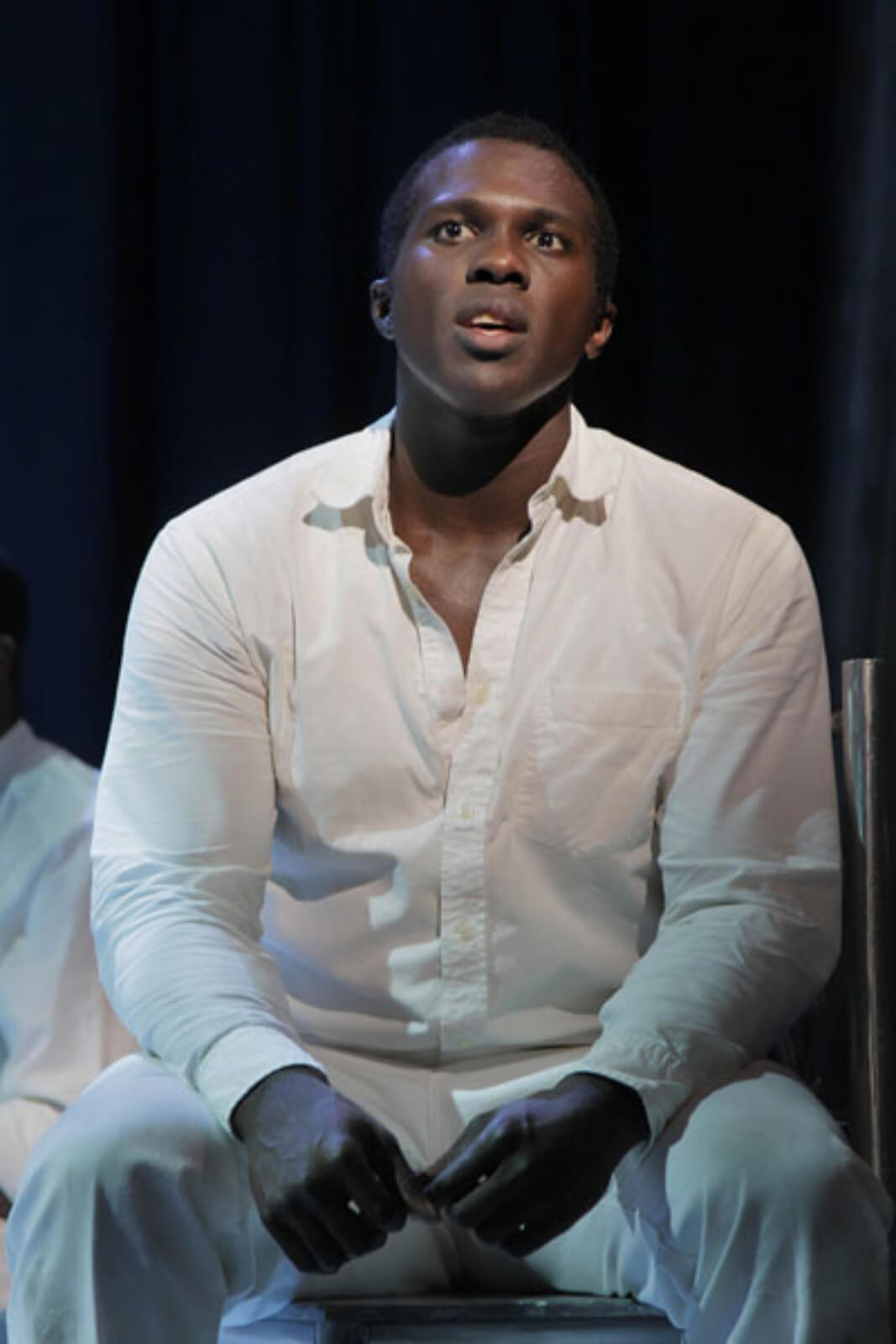 Haywood Patterson (Joshua Henry) singing "Go Back Home". He is singing from his jail cell dressed in white. 