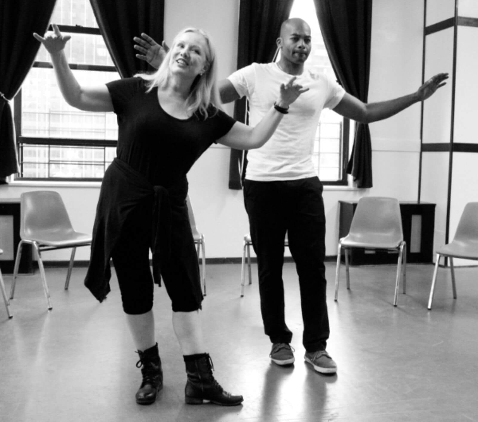 A black and white photo of Susan Stroman and Brandon Victor Dixon rehearsing "You Can't Do Me". They are doing a soft shoe step.