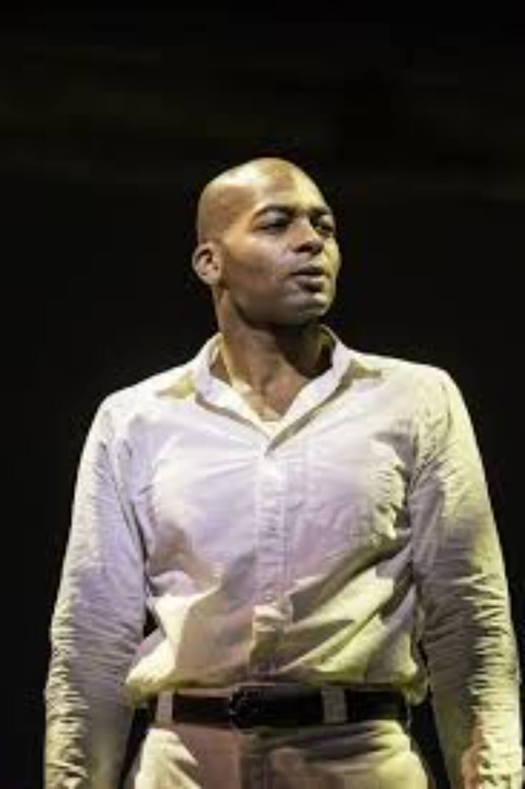 Haywood Patterson (Brandon Victor Dixon) sings the song "Go Back Home". He is wearing a white shirt and white pants. He is in his jail cell.