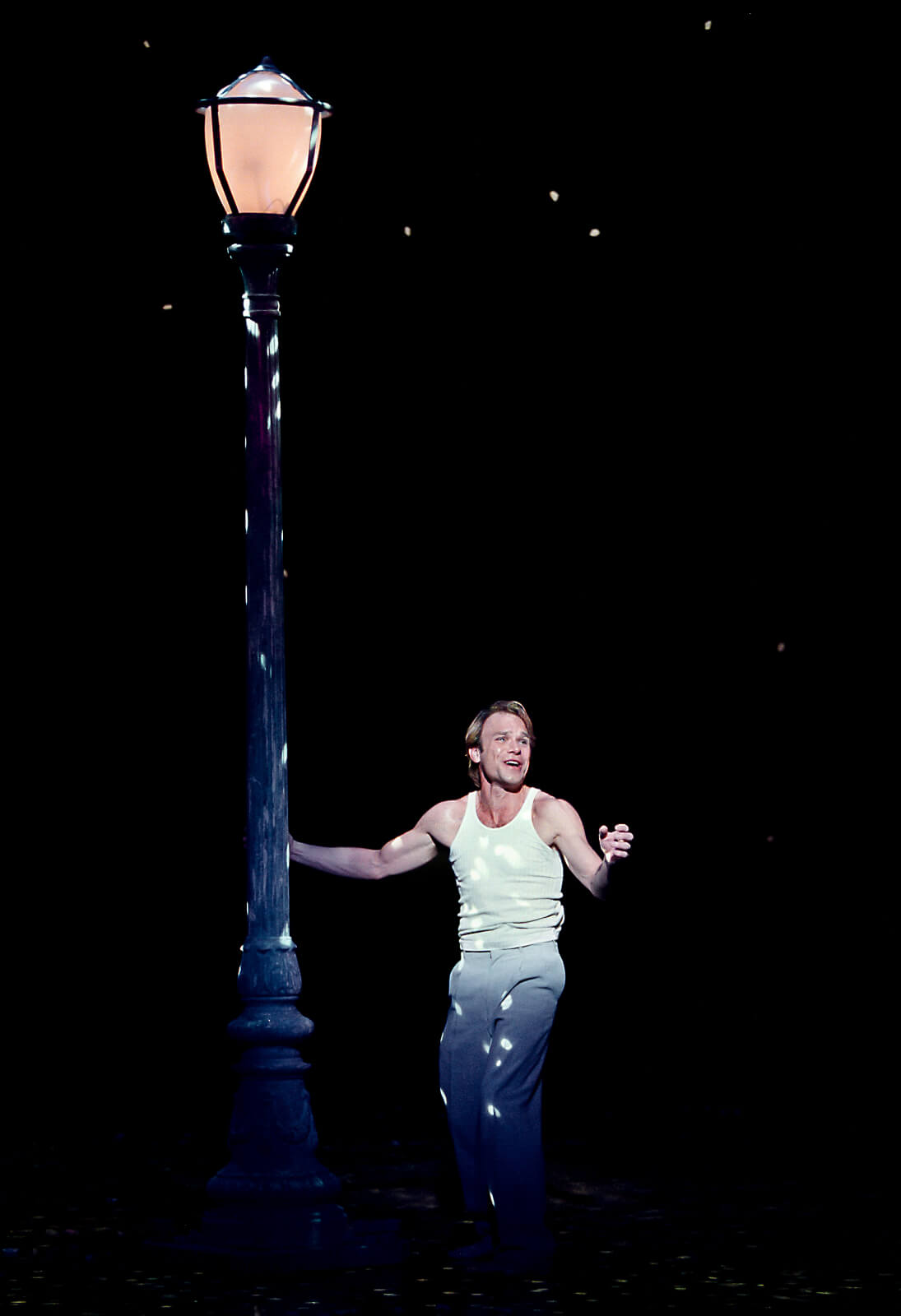 Camille Raquin (Norbert Leo Butz) expressing his feelings beside the lampost.