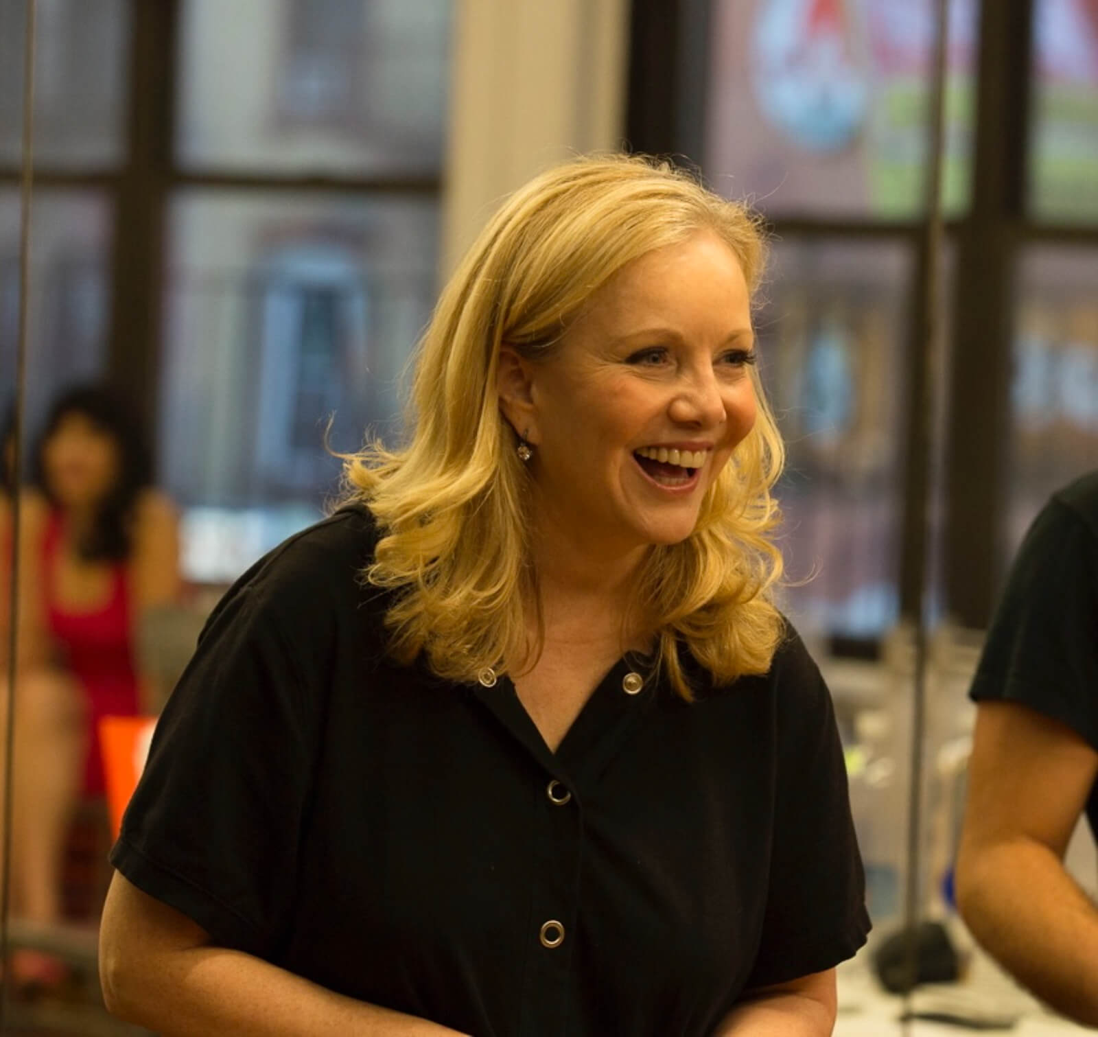 A candid photo of Susan Stroman directing rehearsals. She is explaining a comic moment in the show.