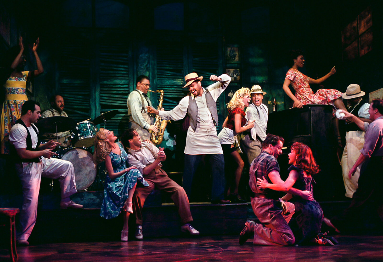 People having fun dancing and making music during the opening bar scene in New Orleans.