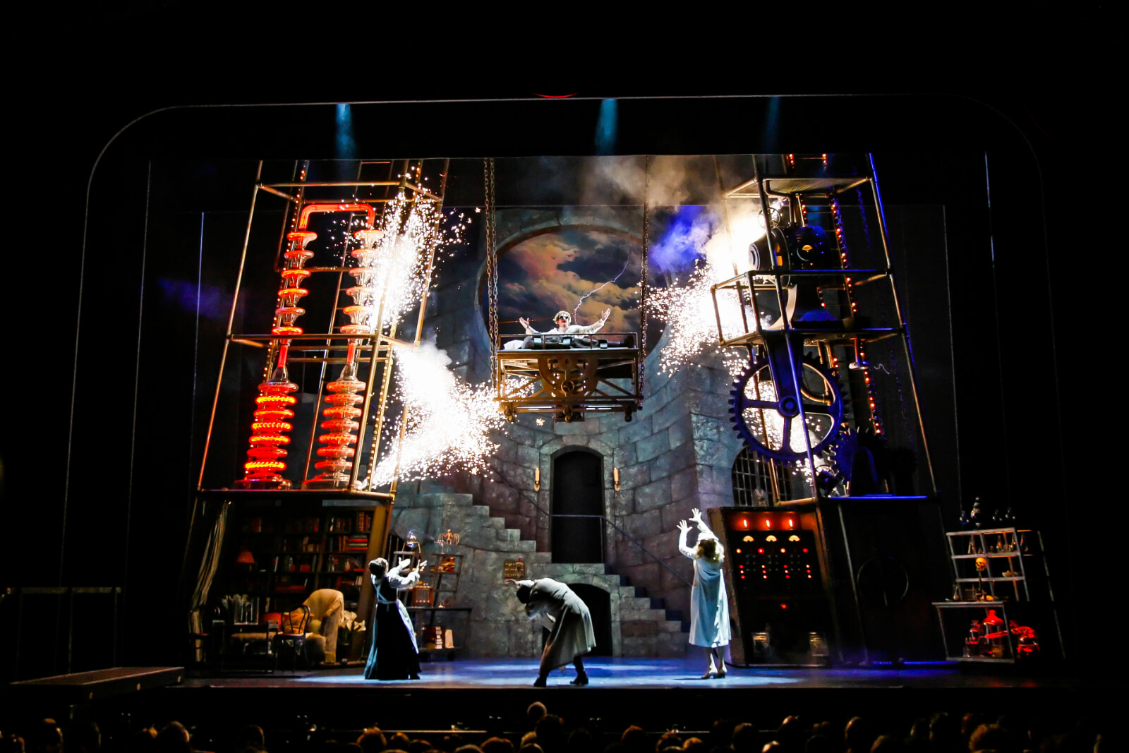 Dr. Frankenstein (Roger Bart) sings "Life, Life", in the lab. He is high in the air with the Monster laying on the lab table, below is Frau Blucher (Andrea Martin), Igor (Chris Fitzgerald ) and Inga (Sutton Foster). They are surrounded by electricity and sparks.