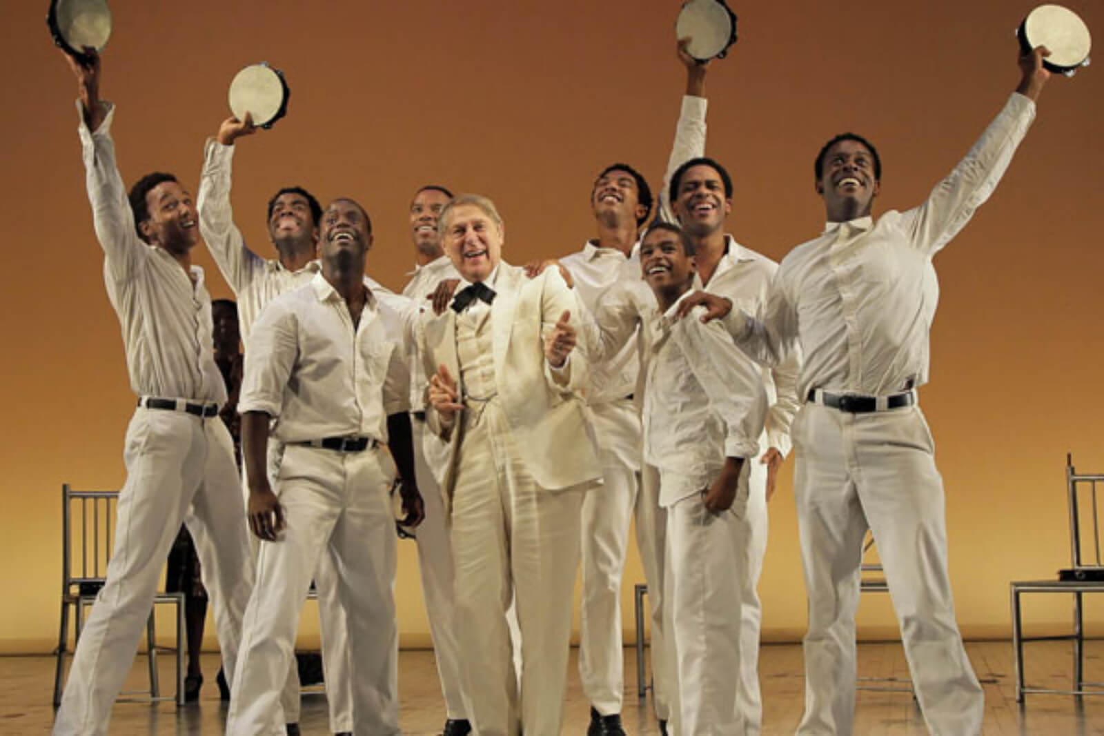 Kendrick Jones, Julias Thomas III, James T. Lane, Rodney Hicks, John Cullum, Christian Dante White, Jeremy Gumbs, Derrick Cobey, and Josh Breckenridge are joyously singing "Shout!" They are all dressed in white.