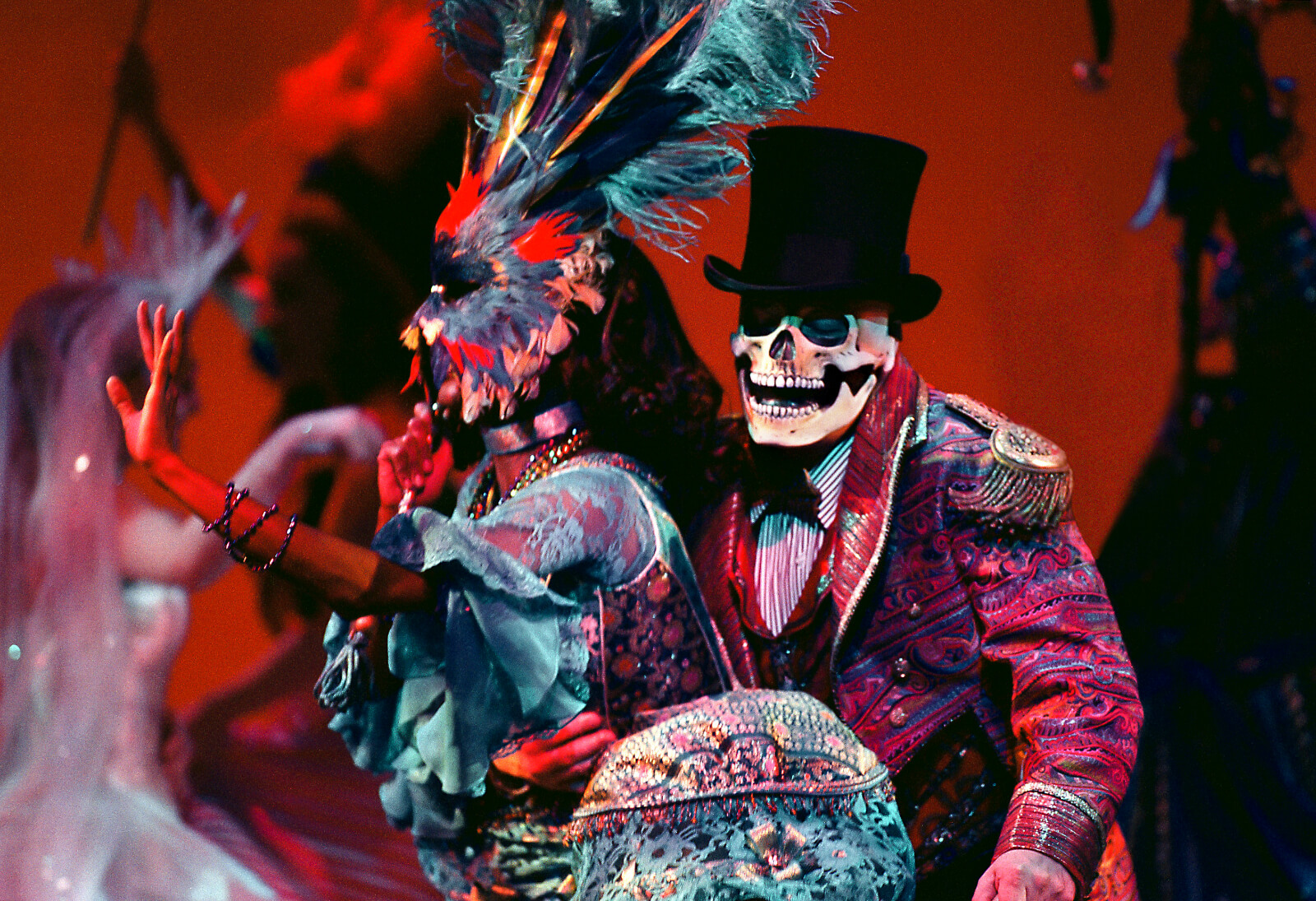Mardi Gras dancers in colorful, extravagant, and outlandish outfits.