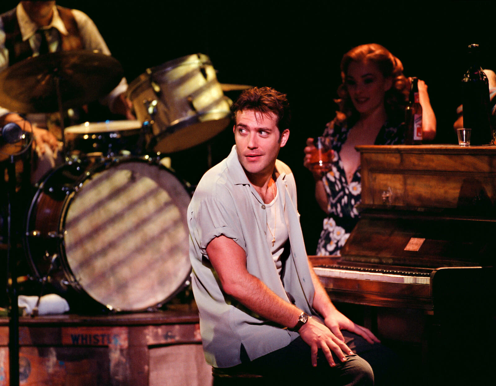 Laurent LeClaire (Craig Bierko) in a piano chair, staring at somebody.