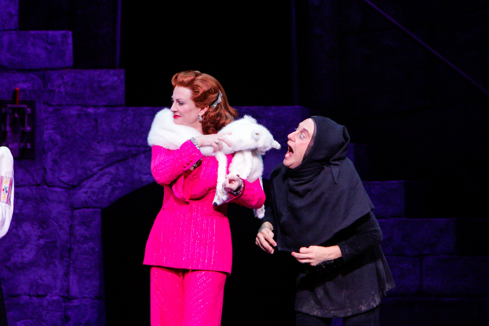 Igor (Chris Fitzgerald) and Elizabeth (Megan Mullally). Igor starts to bite the head off of the white fox stole around her shoulders. 