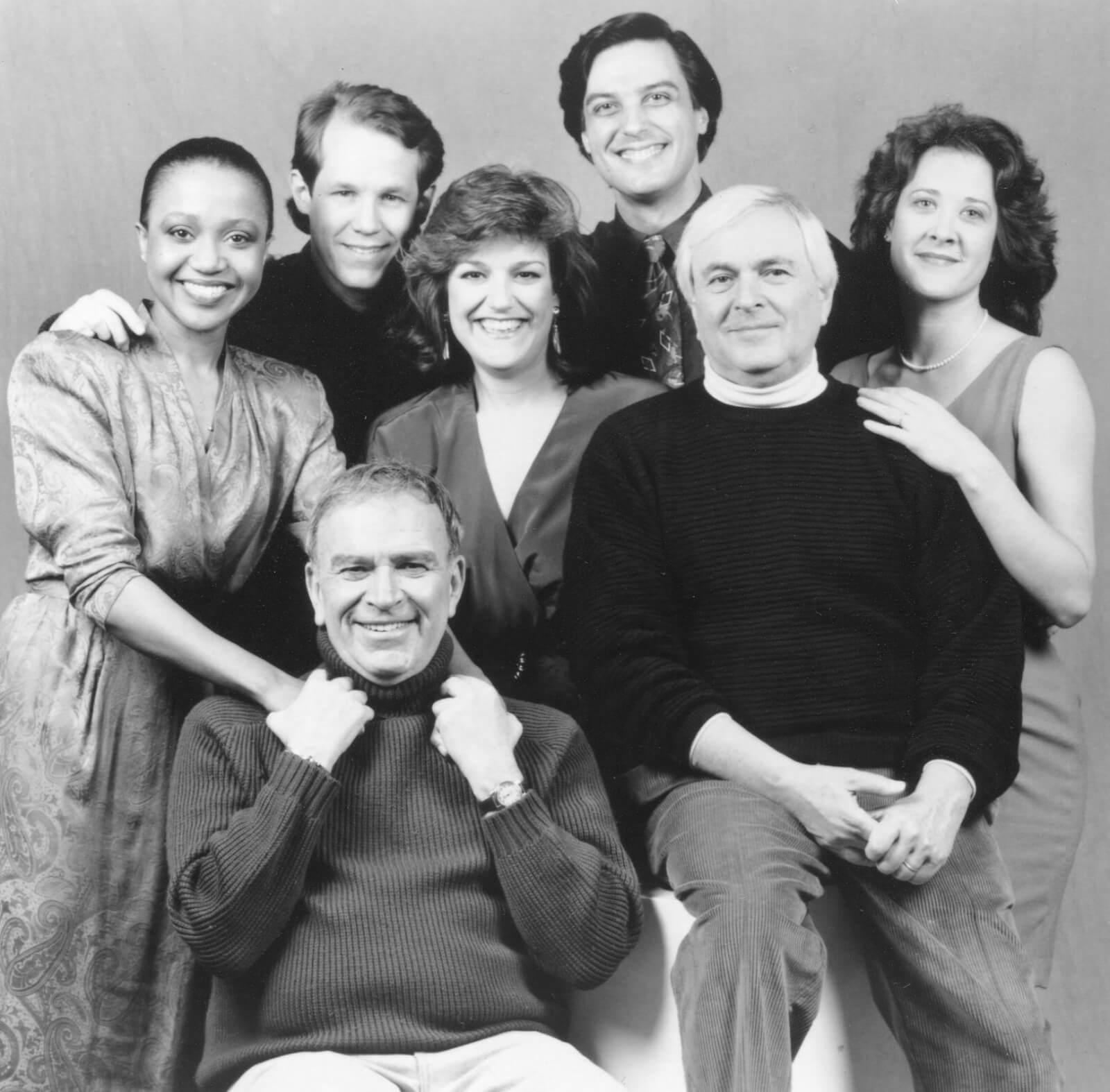 Black and white portrait of the cast and creatives of And The World Goes Round