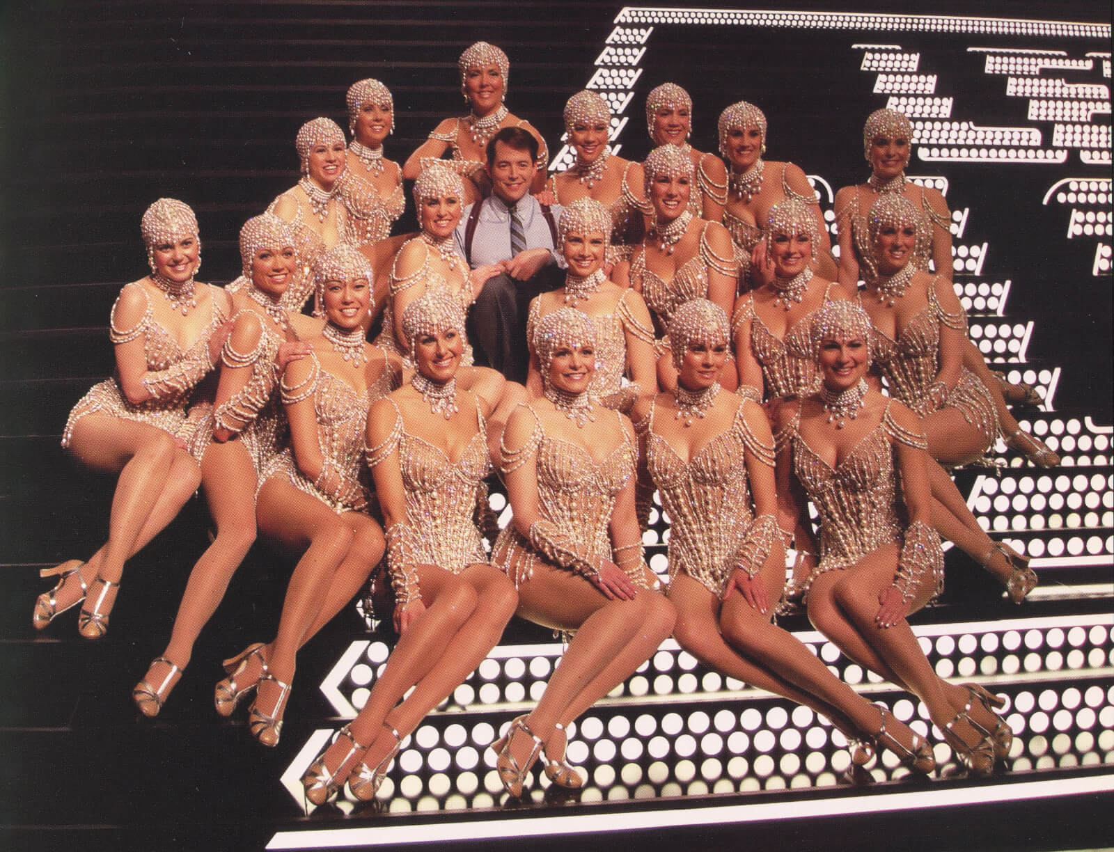 Leo Bloom (Matthew Broderick) and The Pearl Girls. Matthew is surrounded by beautiful woman dressed in pearl costumes. 