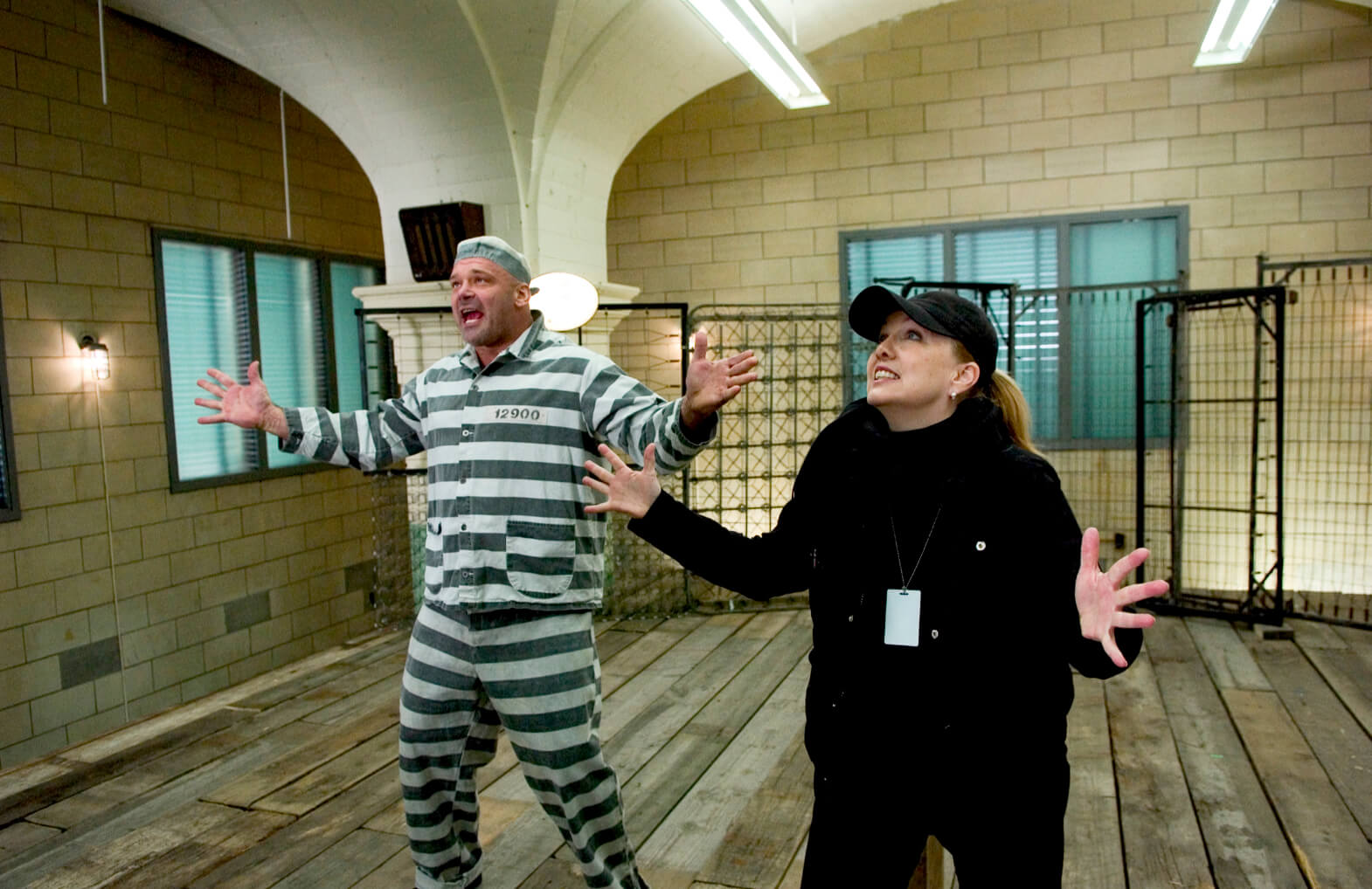 Susan Stroman and jailbird Brian Rogalski rehearsing "Prisoners of Love". Stro is directing Brian on how to deliver the song. Brian is dressed in a jail striped uniform.