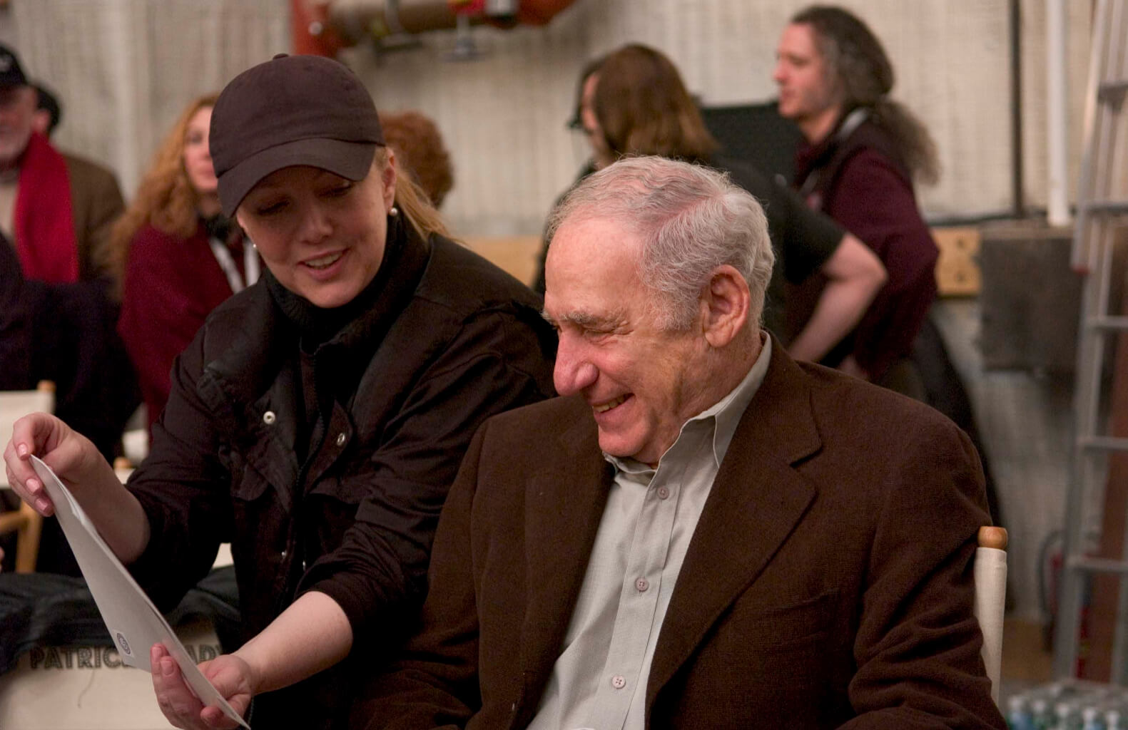 Susan Stroman and Mel Brooks during rehearsal.‍ Stro is showing Mel some photos. 
