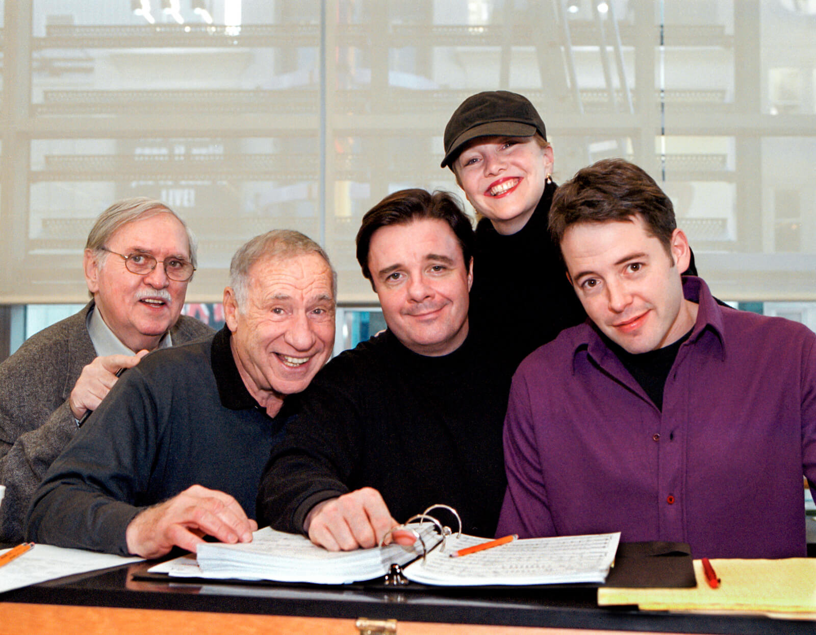 Tom Meehan, Mel Brooks, Nathan Lane, Susan Stroman, and Matthew Broderick in rehearsal for The Producers; huddled around a piano.