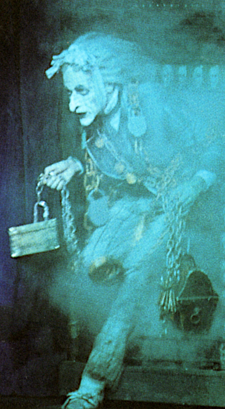 Marley's first entrance: a ghostly man entering through blue and grey smoke.