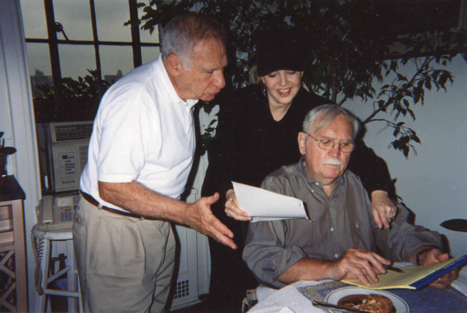 Mel Brooks, Susan Stroman, and Thomas Meehan in an apartment working on the show over food.