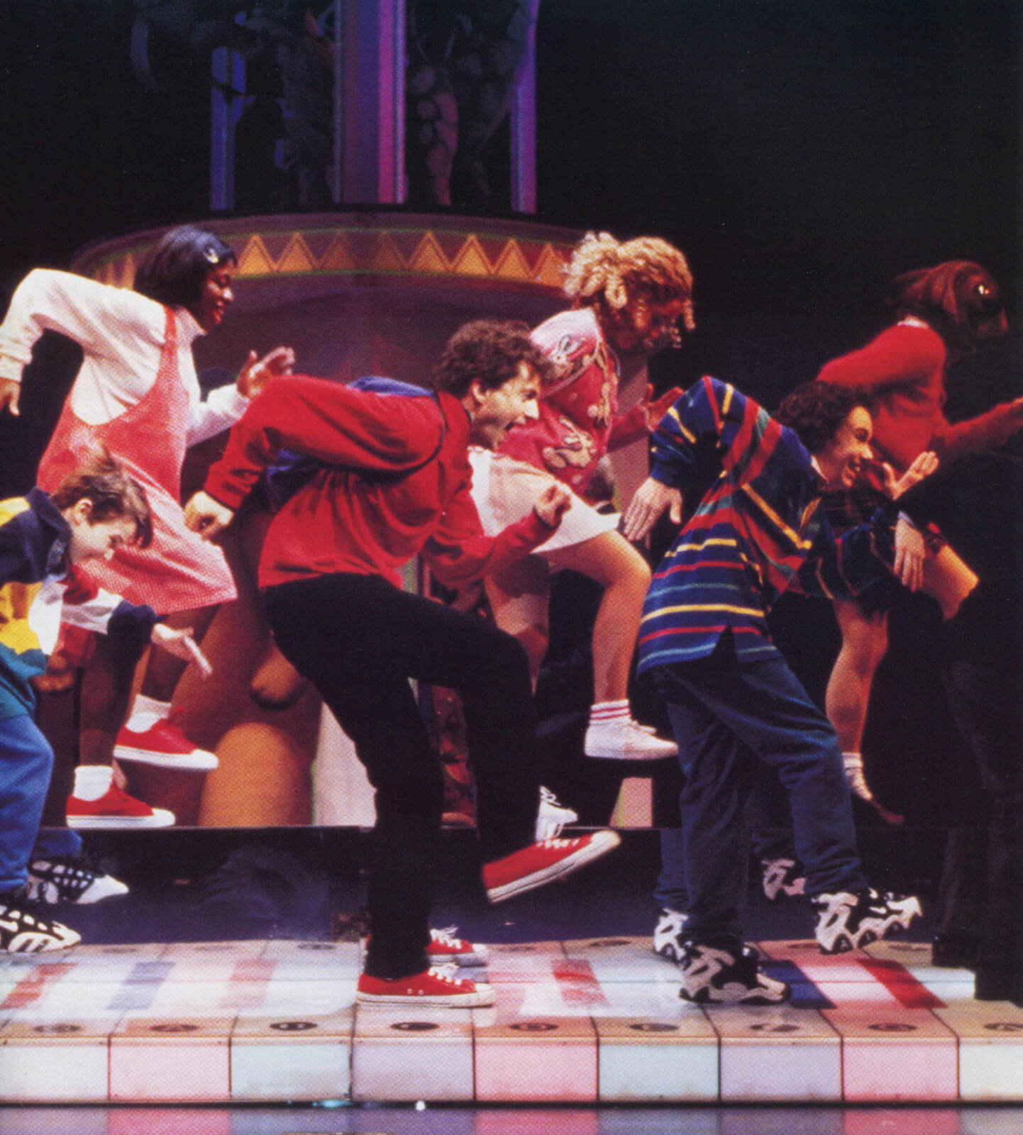 Josh (Daniel Jenkins) and the Big Kids dance on a large keyboard.