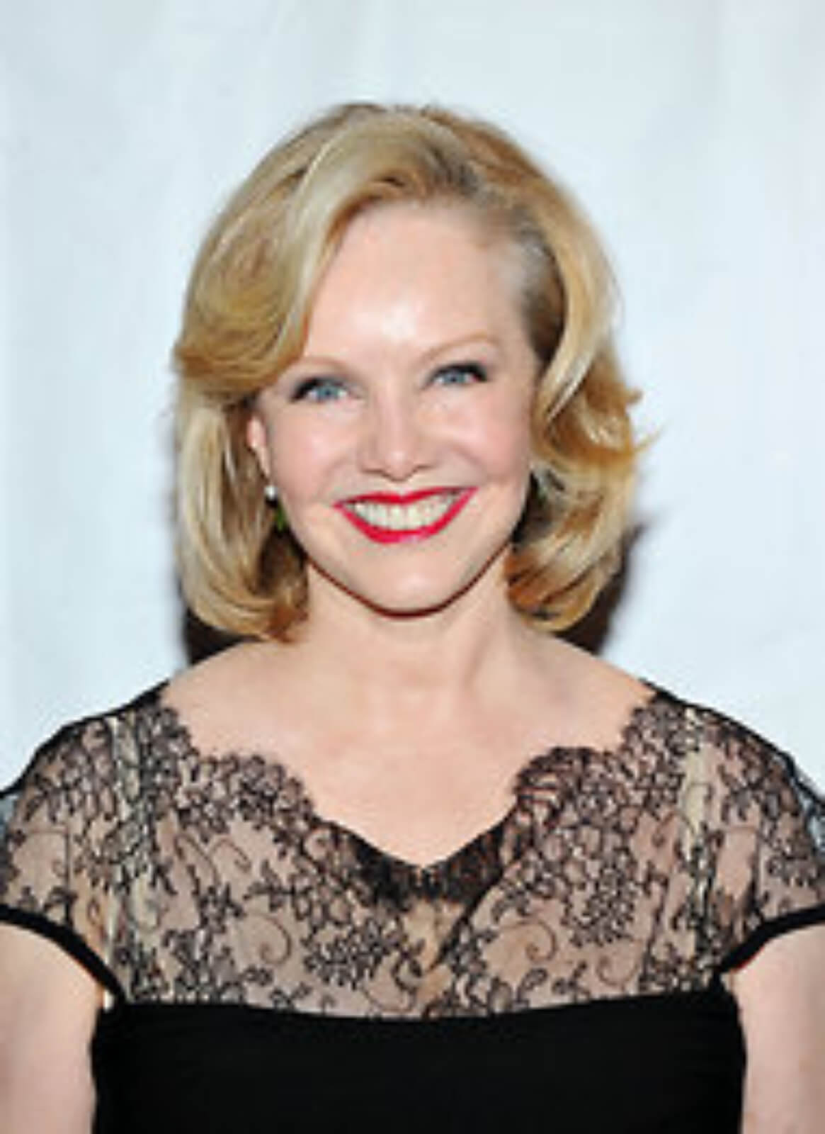 Headshot of Susan Stroman, dressed in black dress, in a portrait taken at a black tie event.