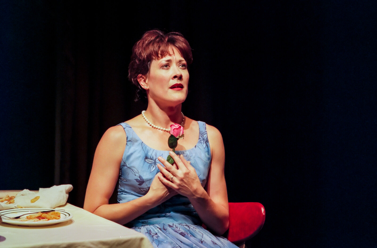 Wife (Karen Ziemba) clutches a pink rose in the final moment of "Did You Move?" from Contact.