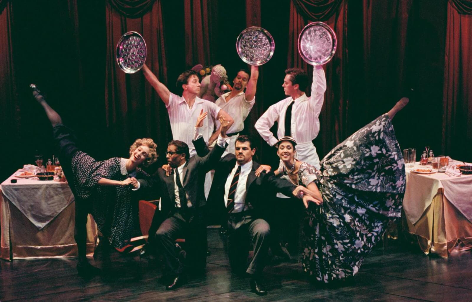 Nina Goldman, Tomé Cousin, Stacey Todd Holt, Robert Wersinger, Peter Gregus, Scott Taylor, and Dana Stackpole in "Did You Move?" from Contact. They are all dressed like waiters and diners.