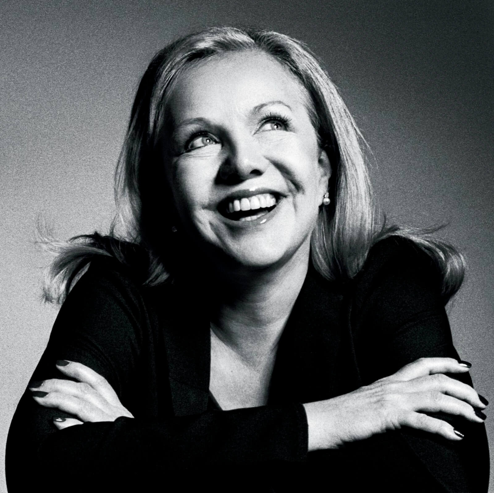 Susan Stroman in black and white looking up joyfully the right left.