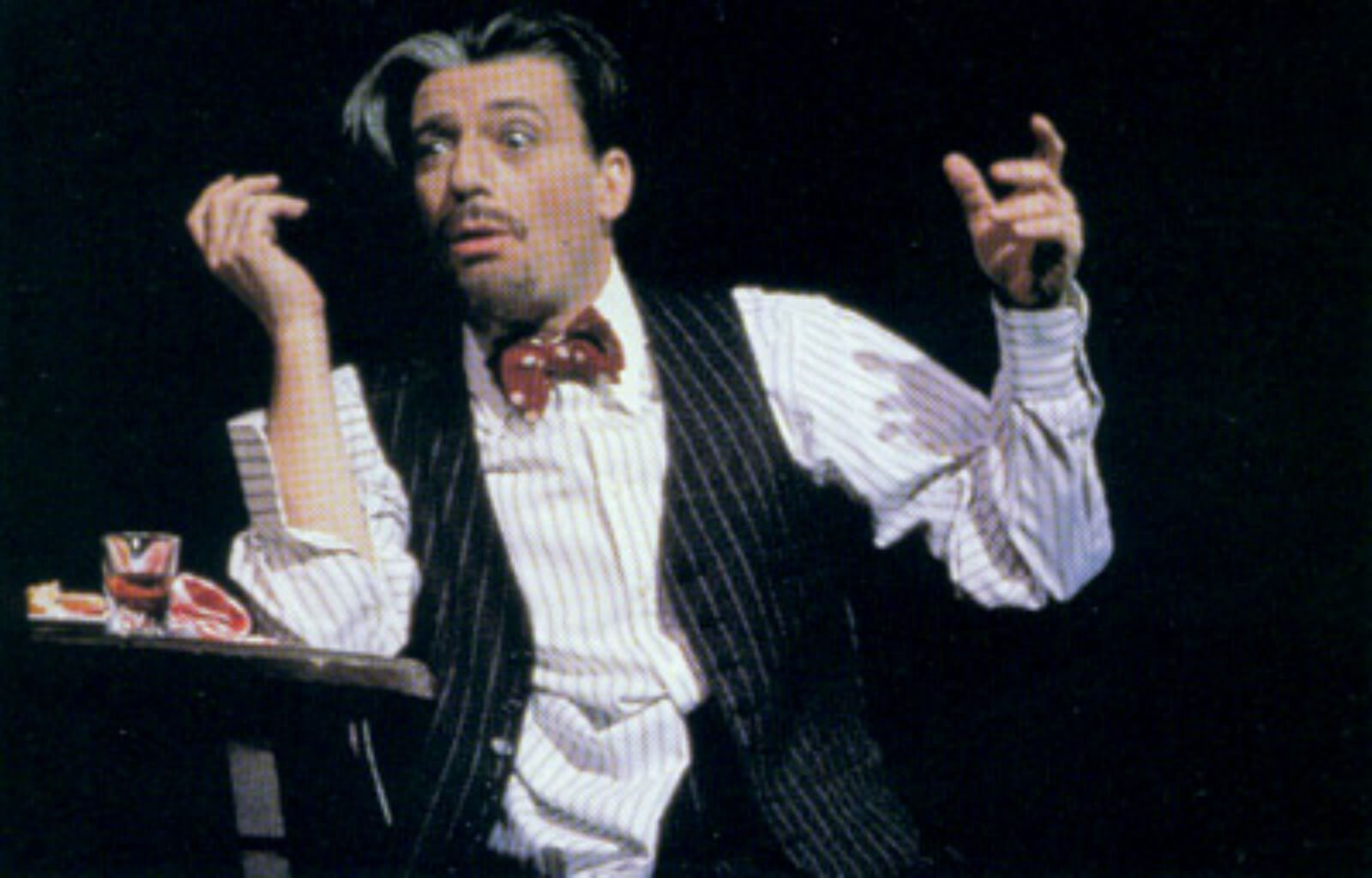 Bela Zangler (Bruce Adler) sits at a table drunk and dejected for the musical number "What Causes That?"