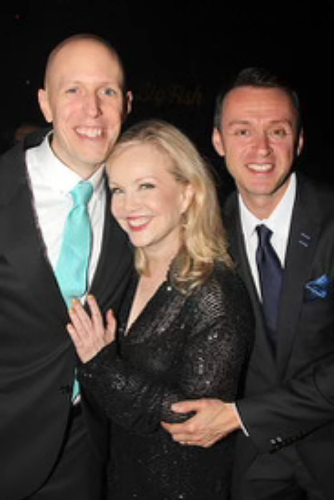 Susan Stroman, in a hug between John August and Andrew Lippa, at the opening night of Big Fish.