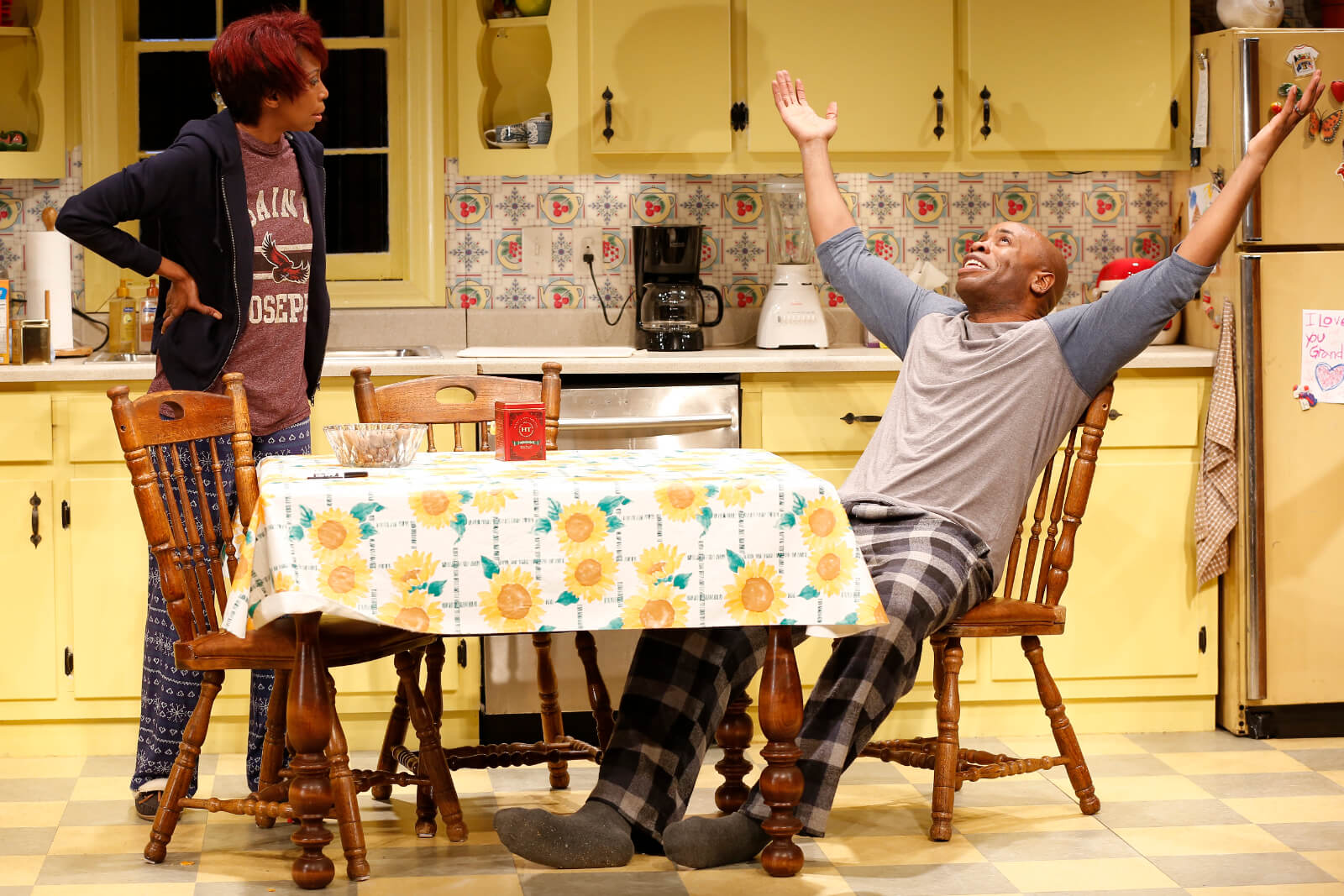Shelly (Sharon Washington) stands with her hands on her hips looking at Donnie (Stephen Conrad Moore) who stretches his arms above his head and gazes upwards