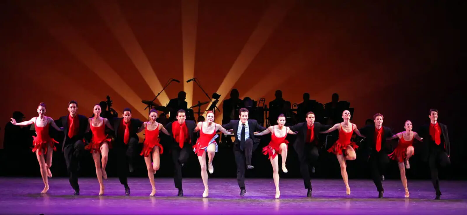 The company of Blossom Got Kissed form a line to move downstage alternating between 14 men and women.