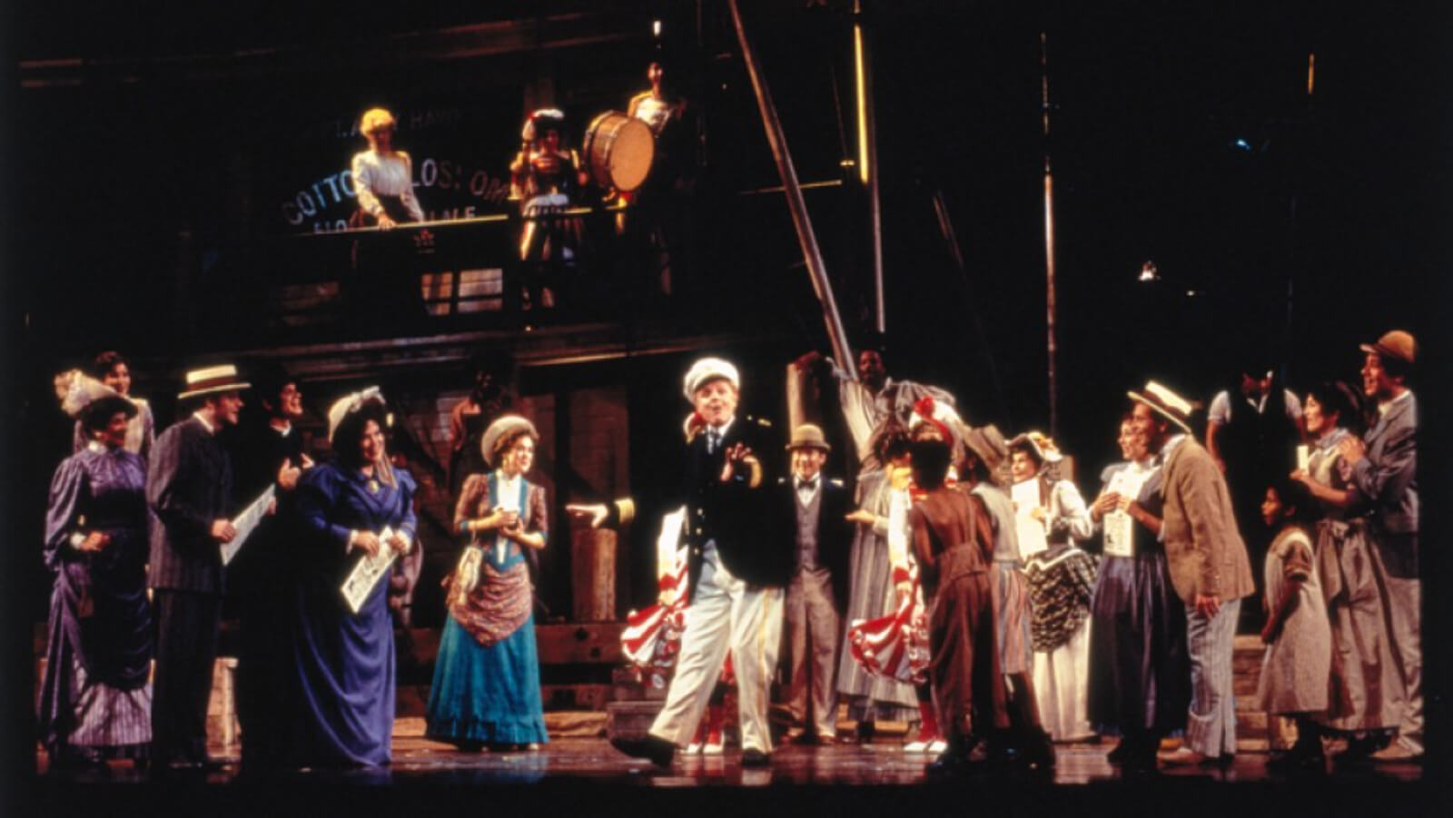 Captain Andy (John McMartin) and the cast, looking happy as he tells the crowd something pleasant and sweet. Everybody seems to be listening to what he's saying.