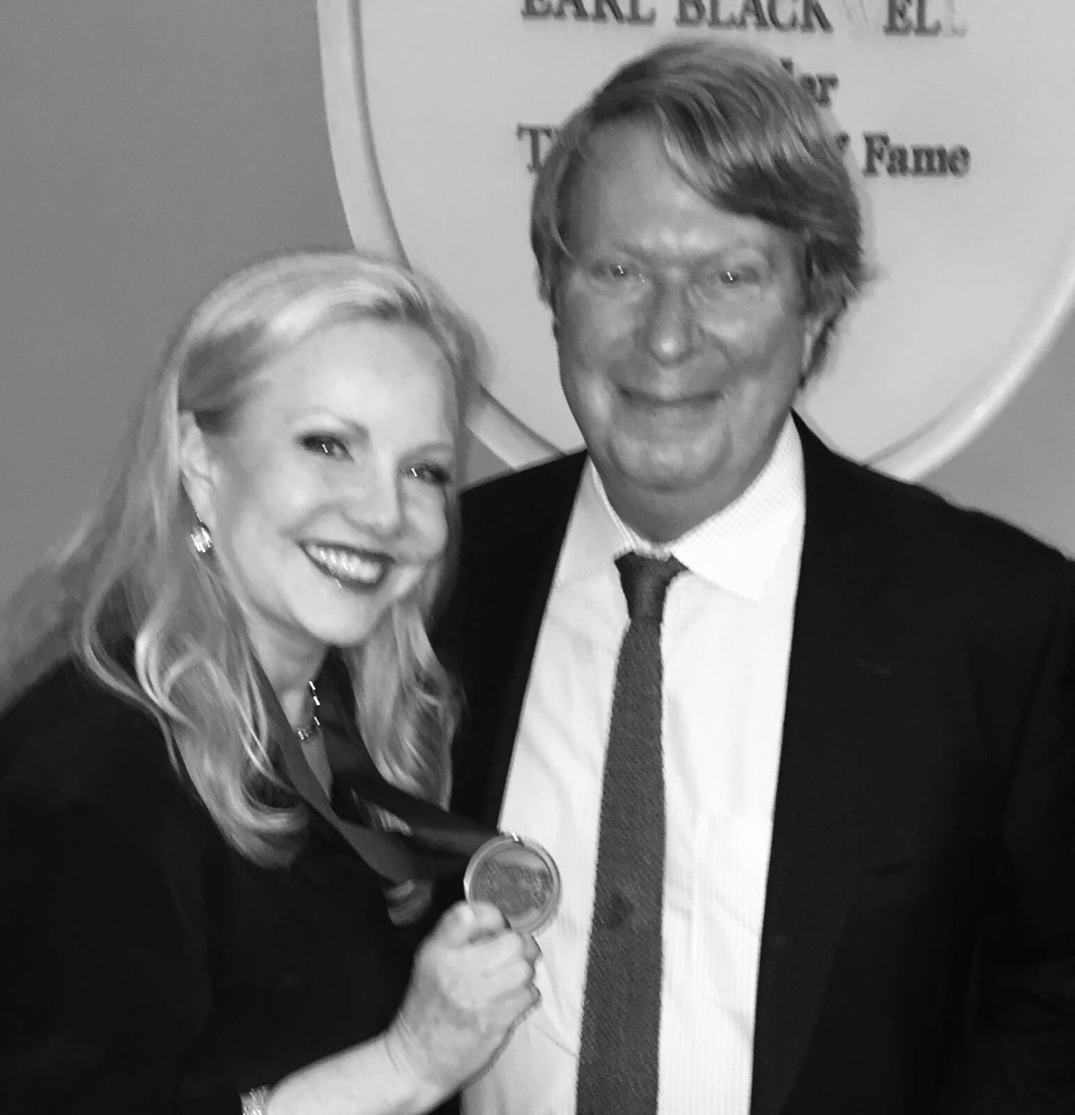 Susan Stroman with Andre Bishop, Artistic Director of Lincoln Center Theater, after being inducted into the Theater Hall of Fame. She is holding the award.